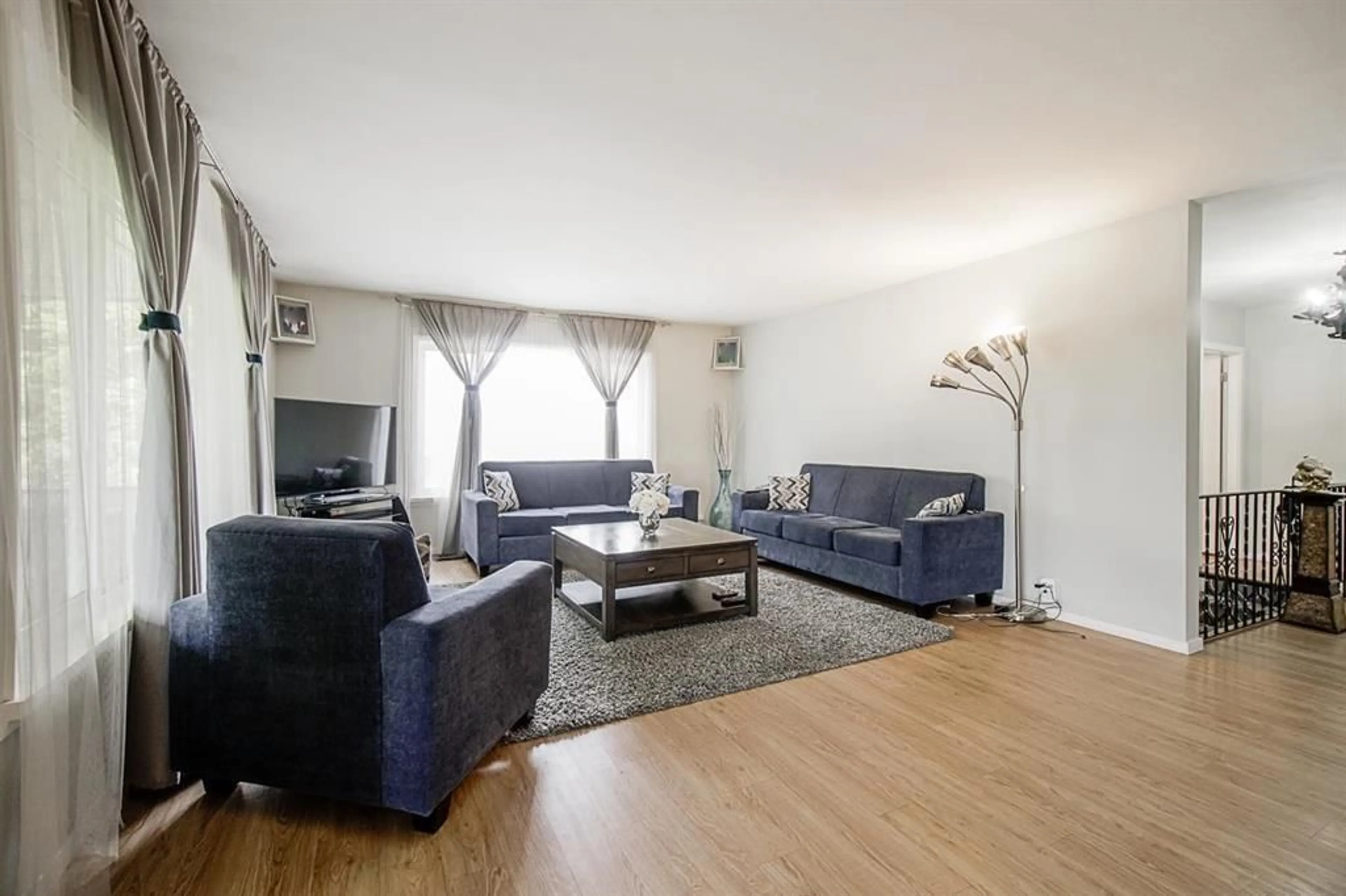 Living room with furniture, wood/laminate floor for 11429 139A STREET, Surrey British Columbia V3R3E9