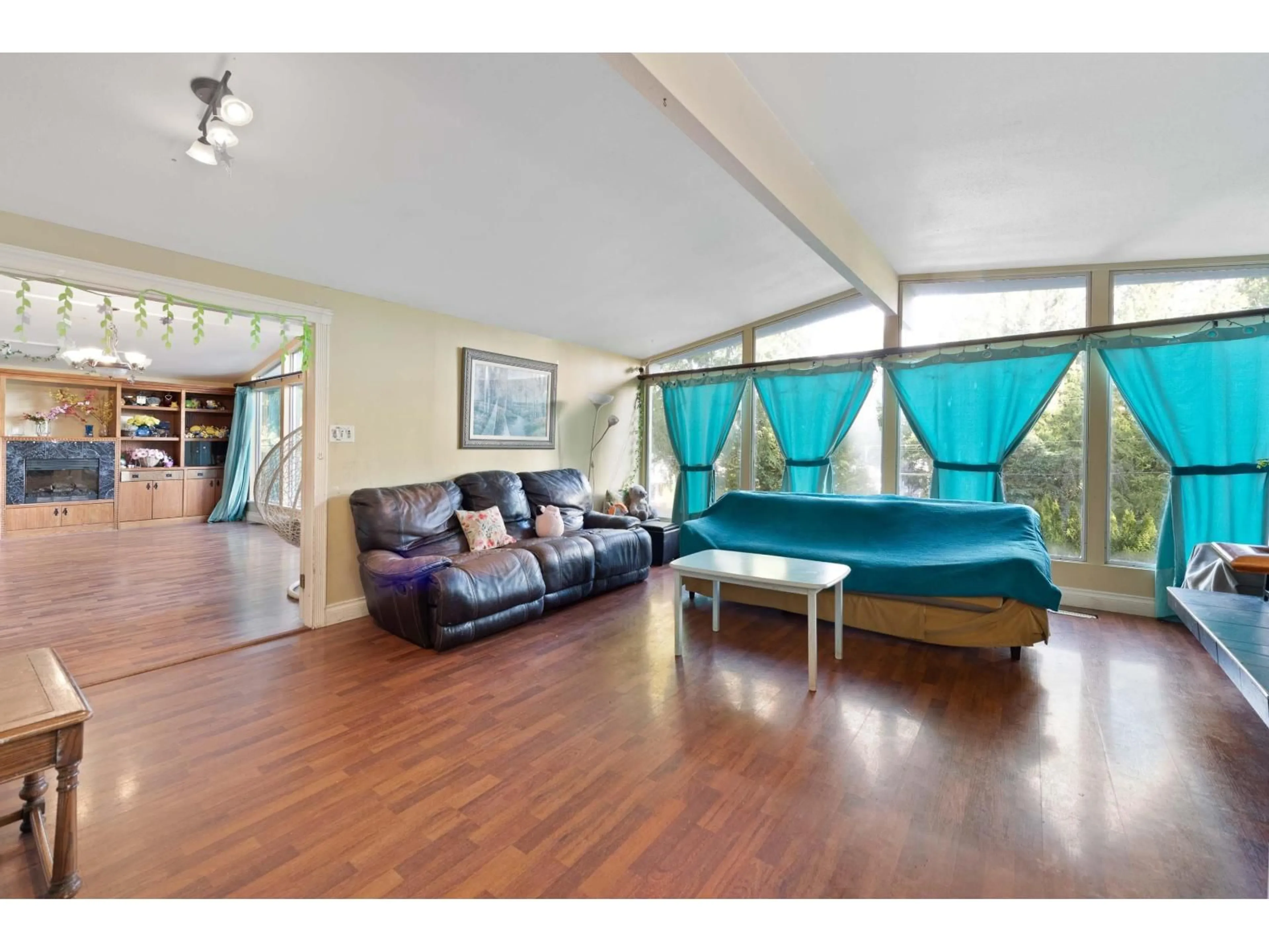 Living room with furniture, wood/laminate floor for 20624 48 AVENUE, Langley British Columbia V3A3L6