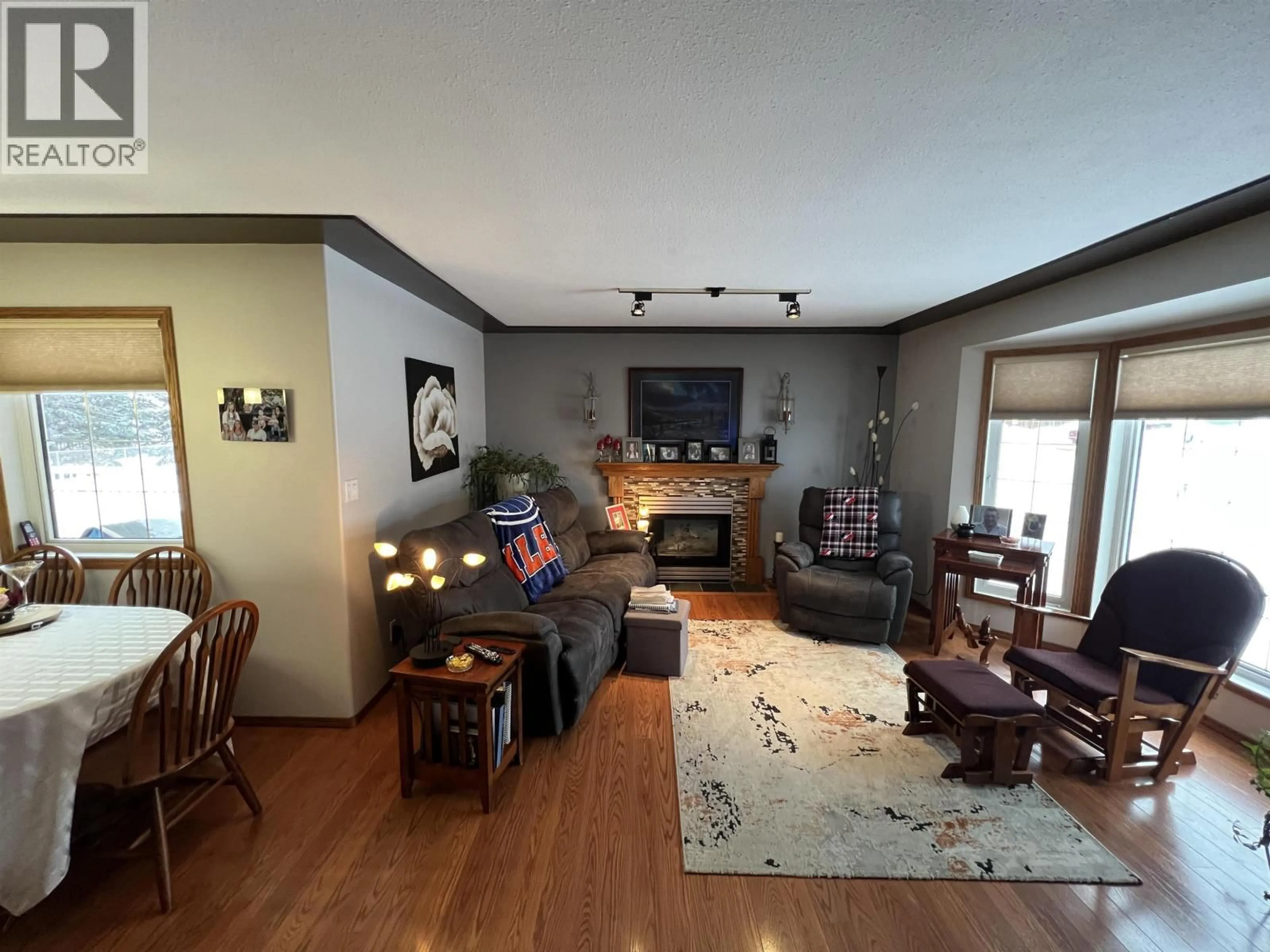 Living room with furniture, wood/laminate floor for 5323 MOUNTAINVIEW DRIVE, Fort Nelson British Columbia V0C1R0