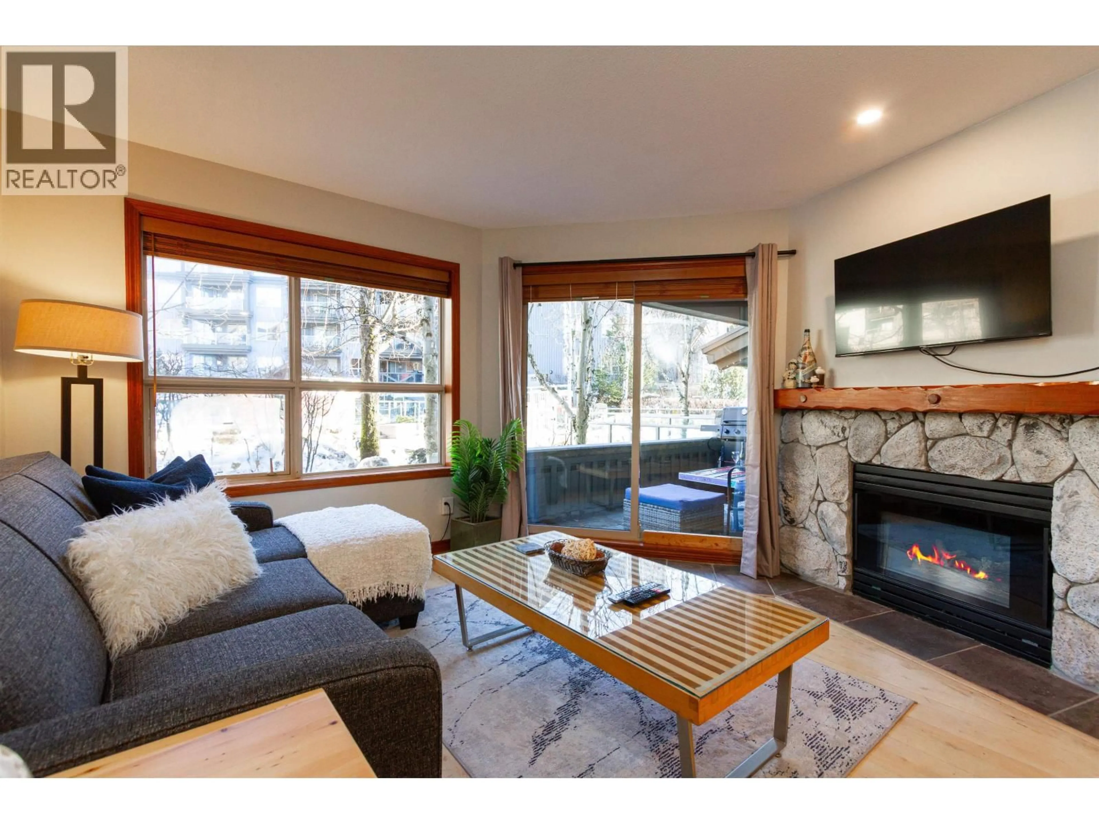 Living room with furniture, wood/laminate floor for 107 - 4800 SPEARHEAD DRIVE, Whistler British Columbia V8E1G1