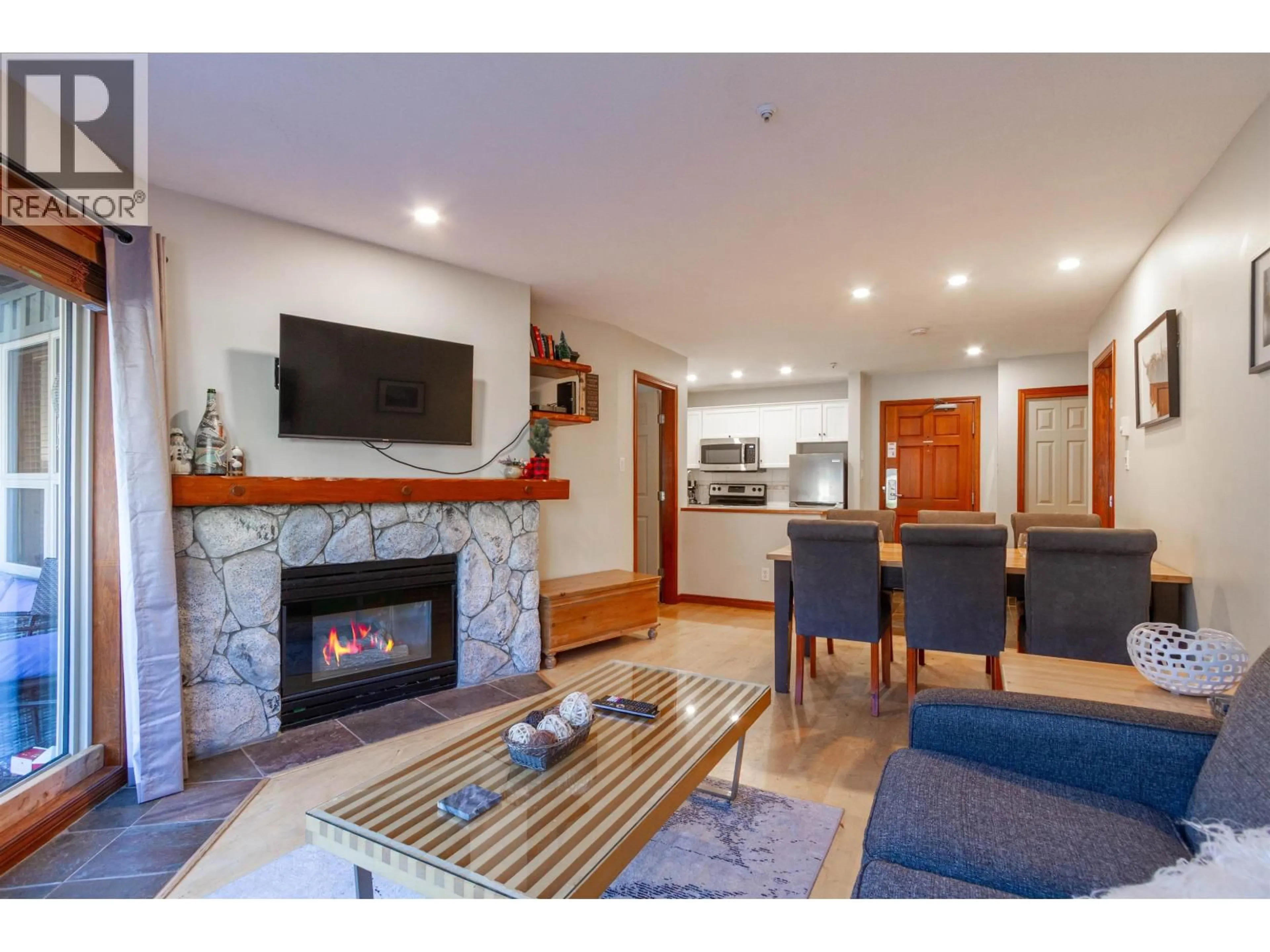 Living room with furniture, wood/laminate floor for 107 - 4800 SPEARHEAD DRIVE, Whistler British Columbia V8E1G1