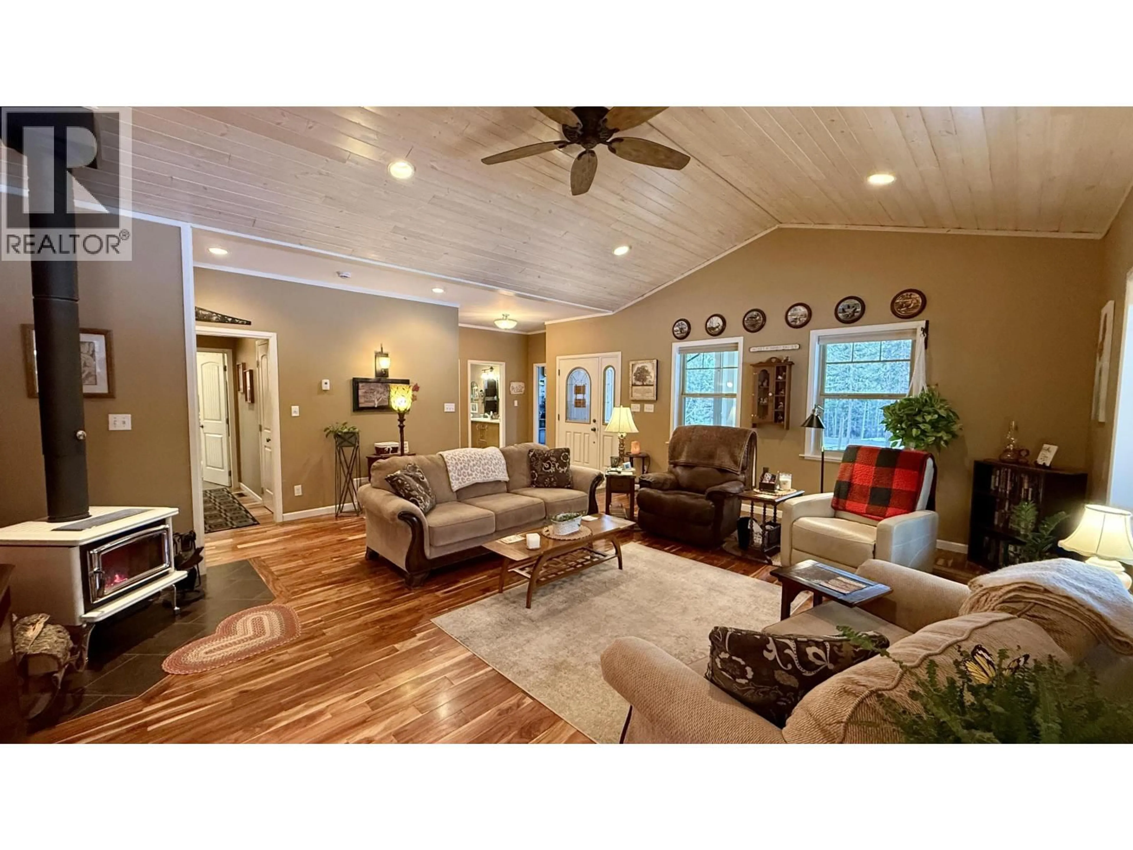 Living room with furniture, wood/laminate floor for 5352 QUA PLACE, 108 Mile Ranch British Columbia V0K2Z0