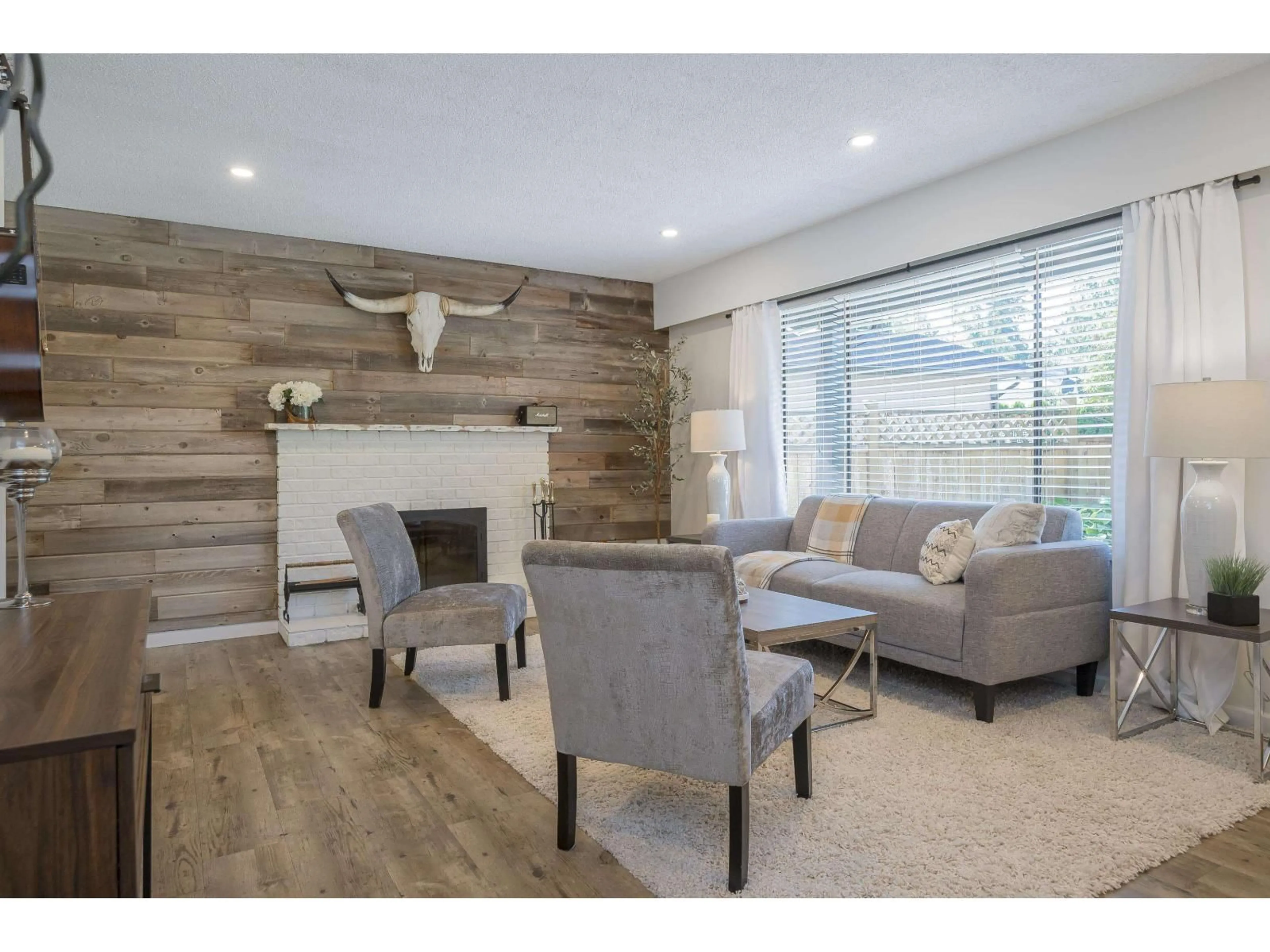 Living room with furniture, wood/laminate floor for 4640 203A STREET, Langley British Columbia V3A5K1