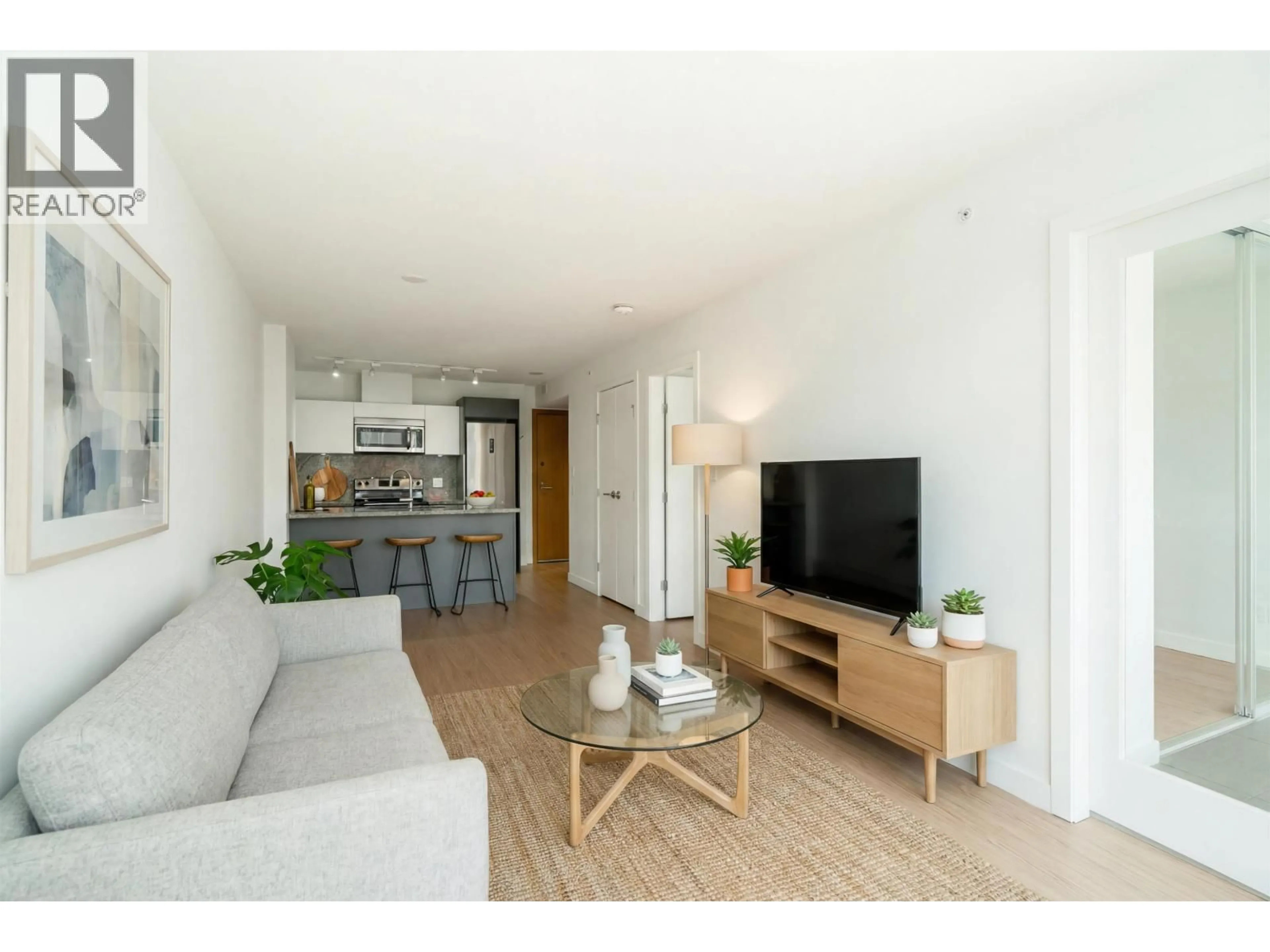 Living room with furniture, wood/laminate floor for 716 - 188 KEEFER STREET, Vancouver British Columbia V6A0E3