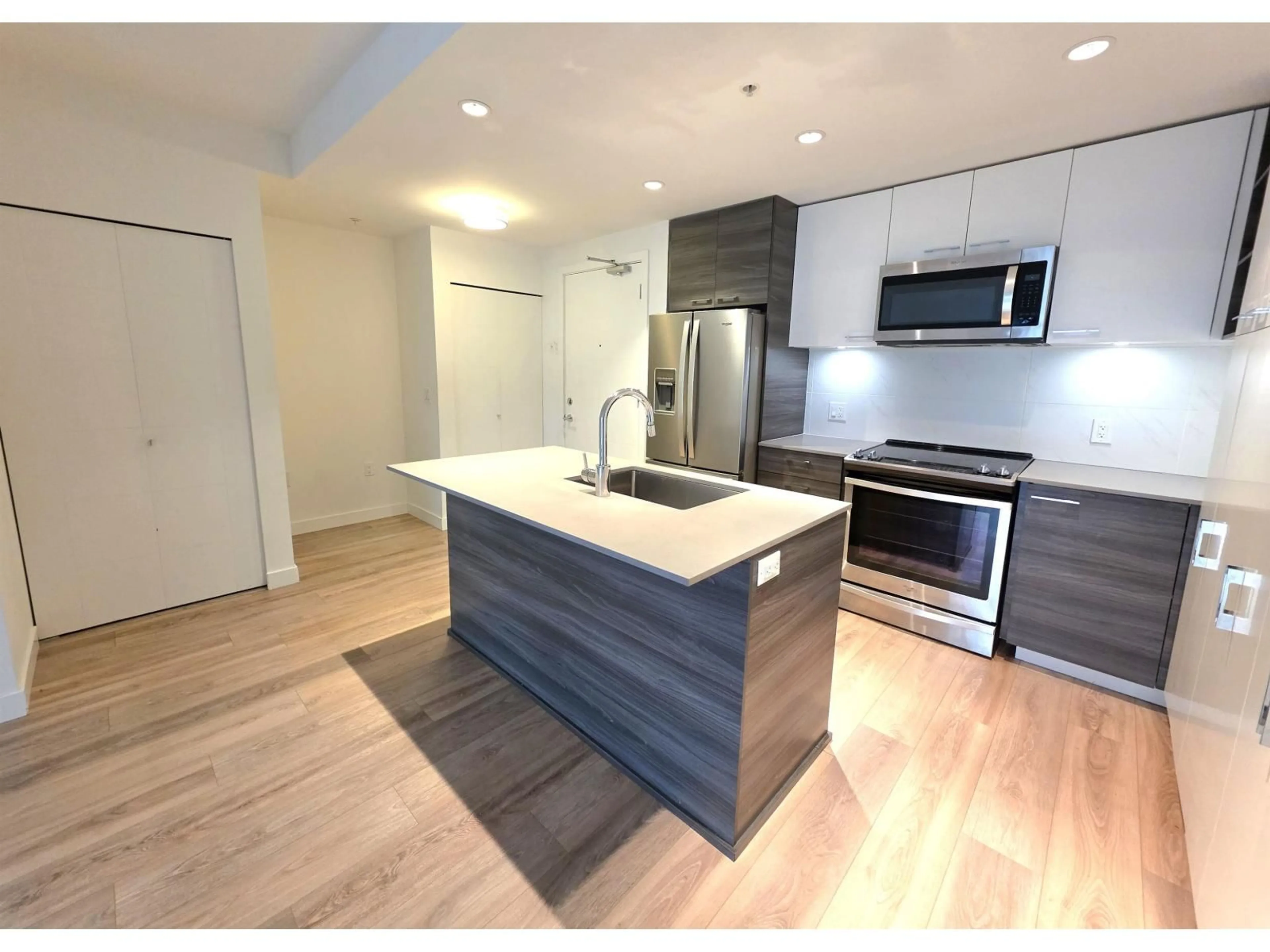 Open concept kitchen, wood/laminate floor for 104 - 10581 140 STREET, Surrey British Columbia V3T0M7