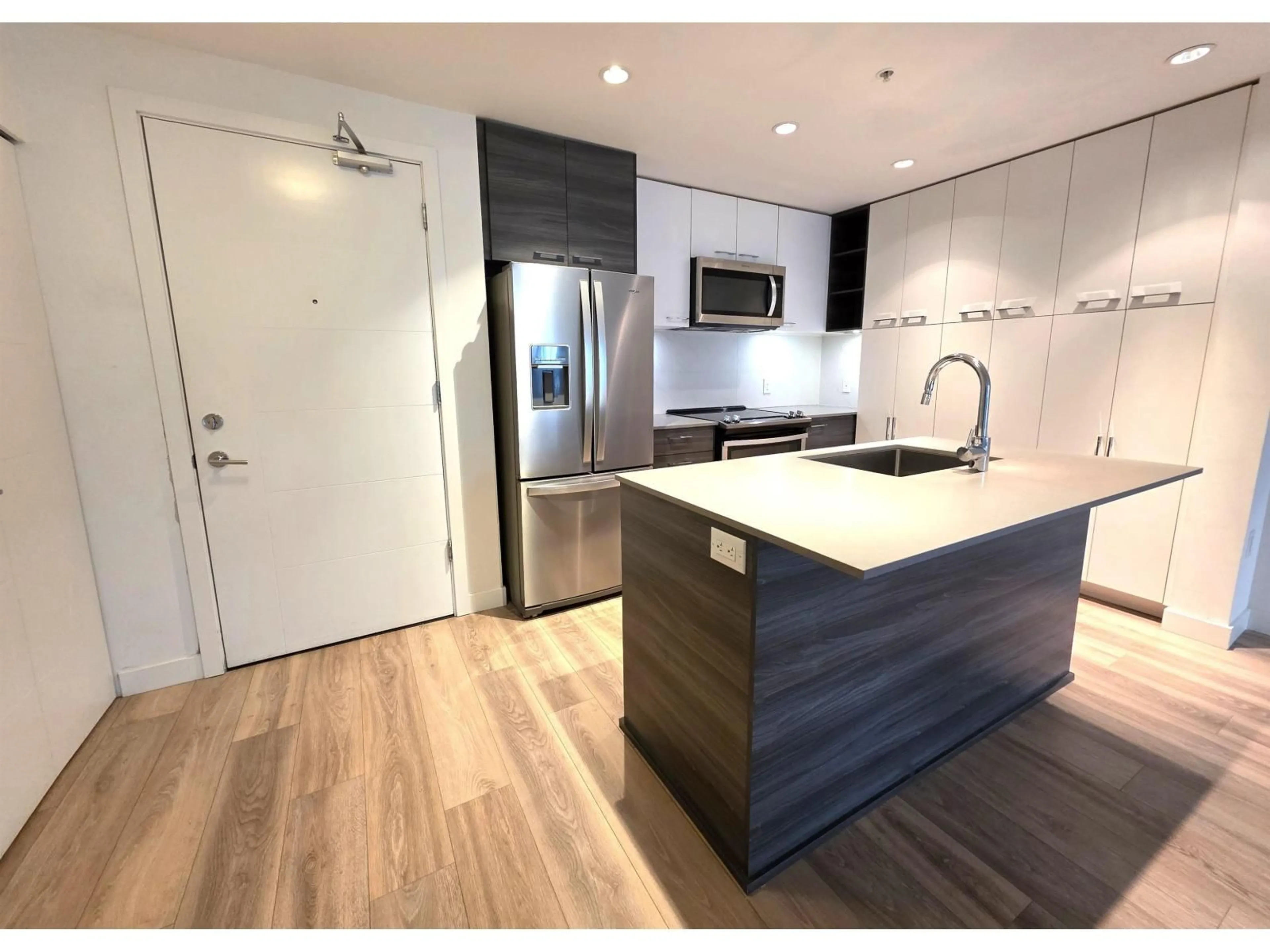 Open concept kitchen, wood/laminate floor for 104 - 10581 140 STREET, Surrey British Columbia V3T0M7