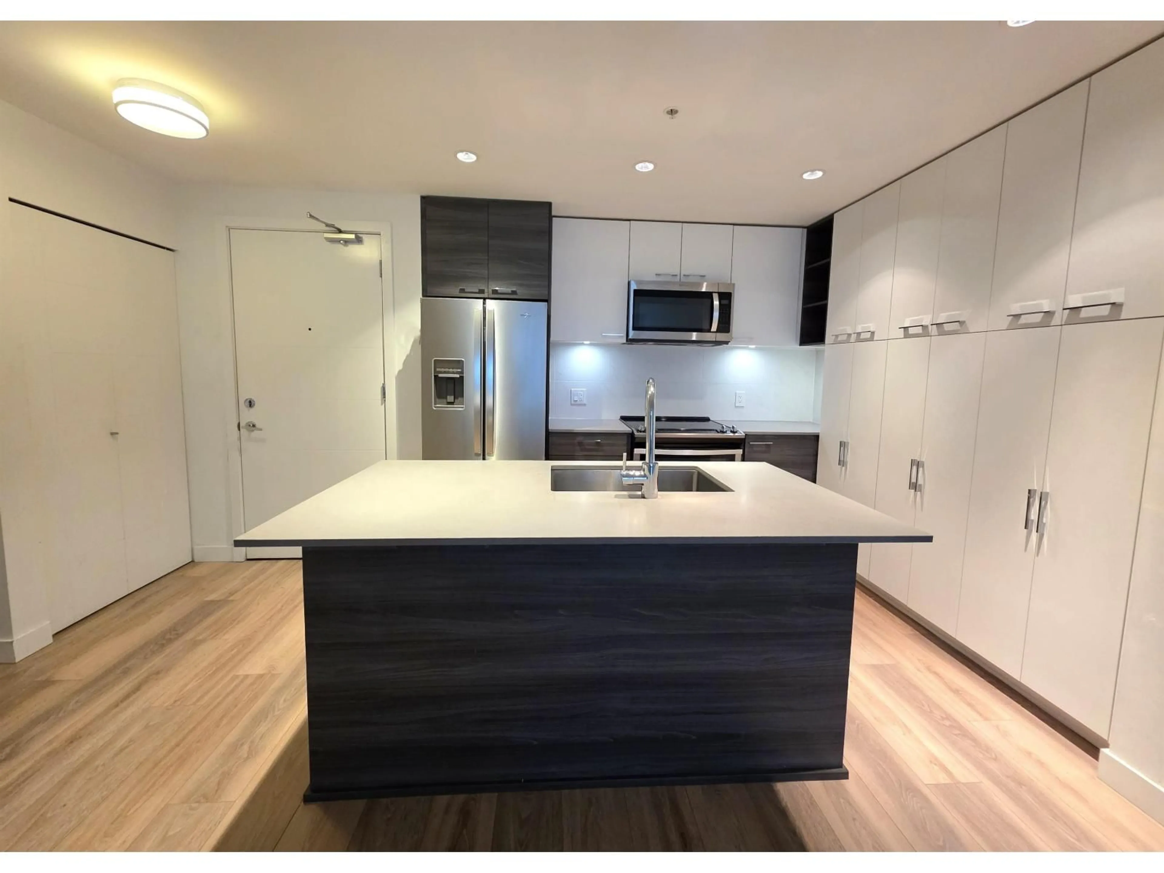 Open concept kitchen, wood/laminate floor for 104 - 10581 140 STREET, Surrey British Columbia V3T0M7