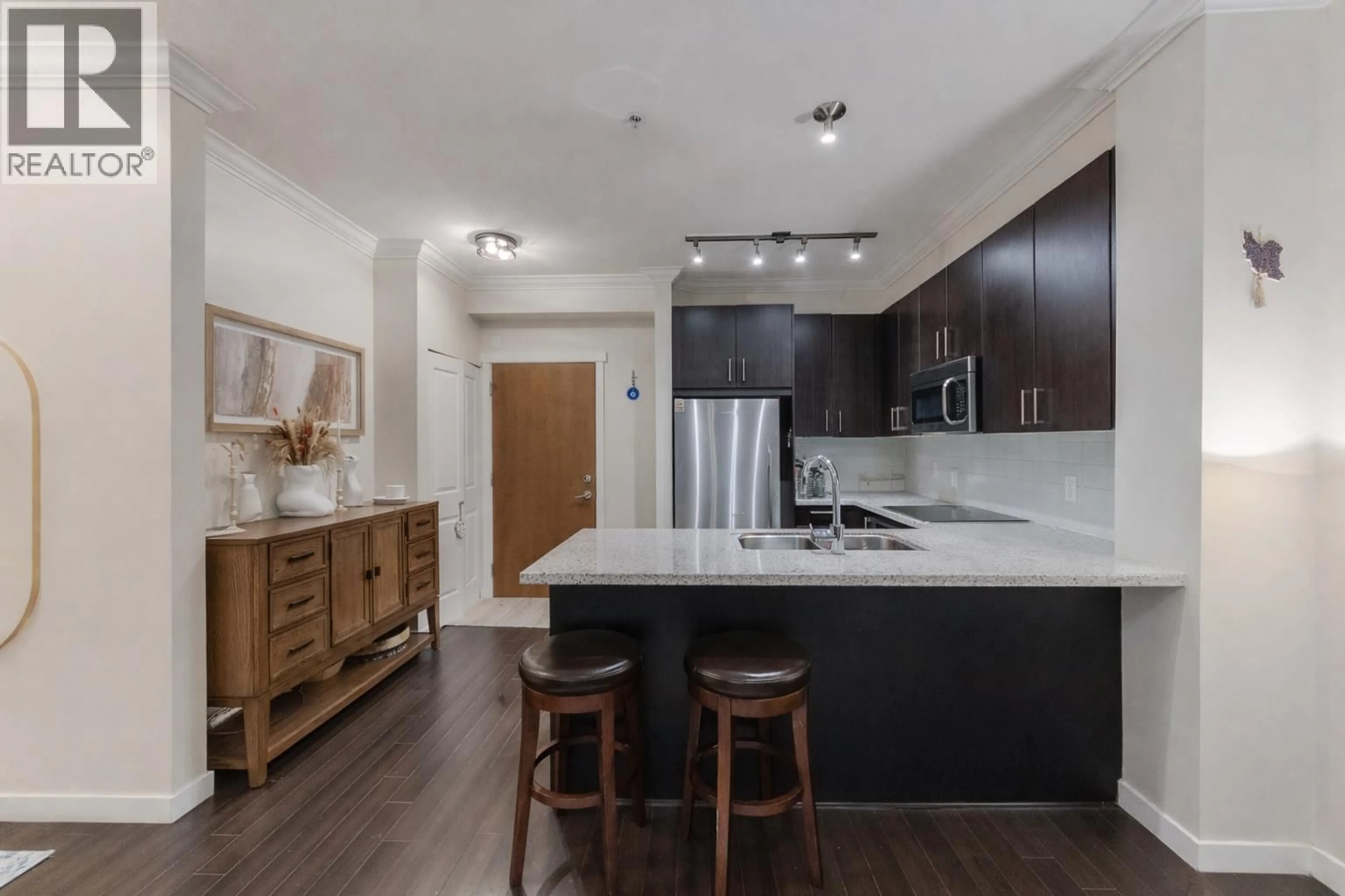 Open concept kitchen, wood/laminate floor for 217 - 119 22ND STREET, North Vancouver British Columbia V7M0B4