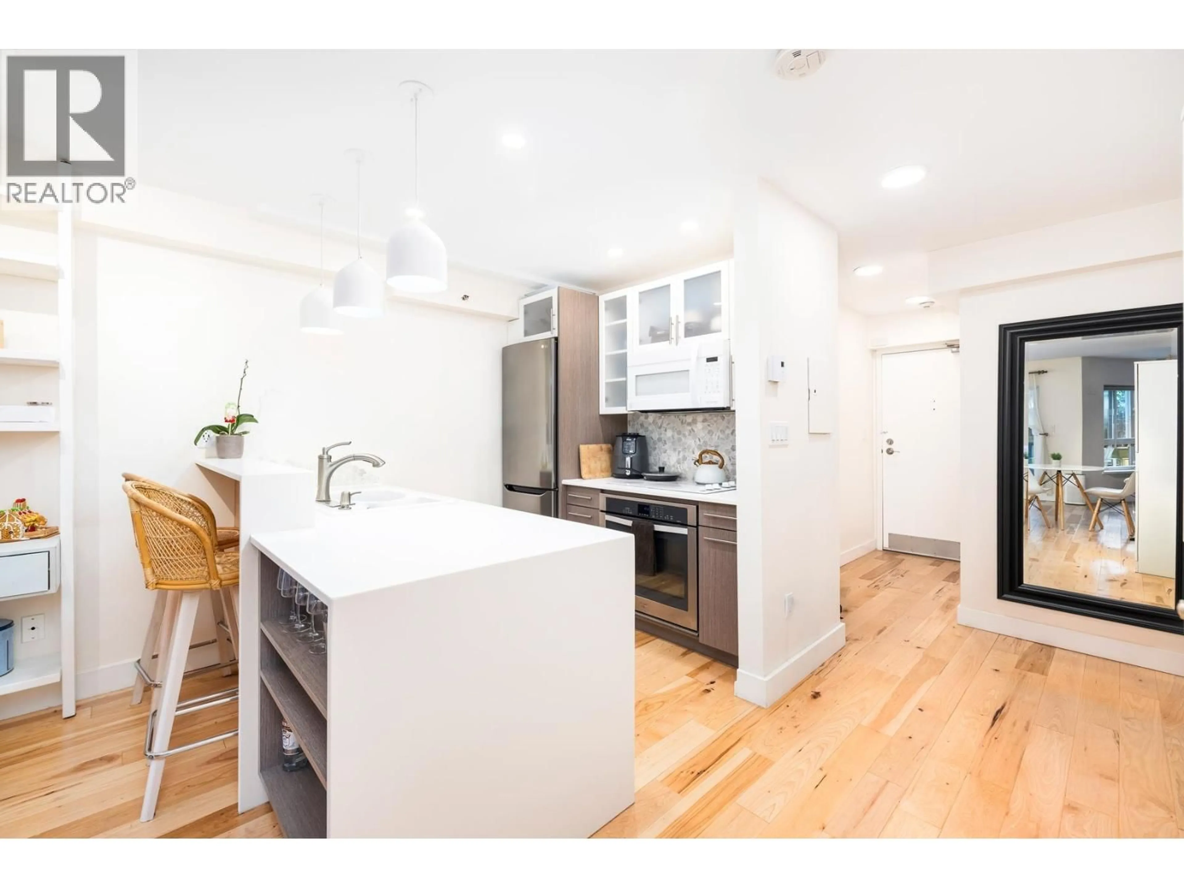 Open concept kitchen, wood/laminate floor for 112 - 825 7TH AVENUE, Vancouver British Columbia V5T1P4