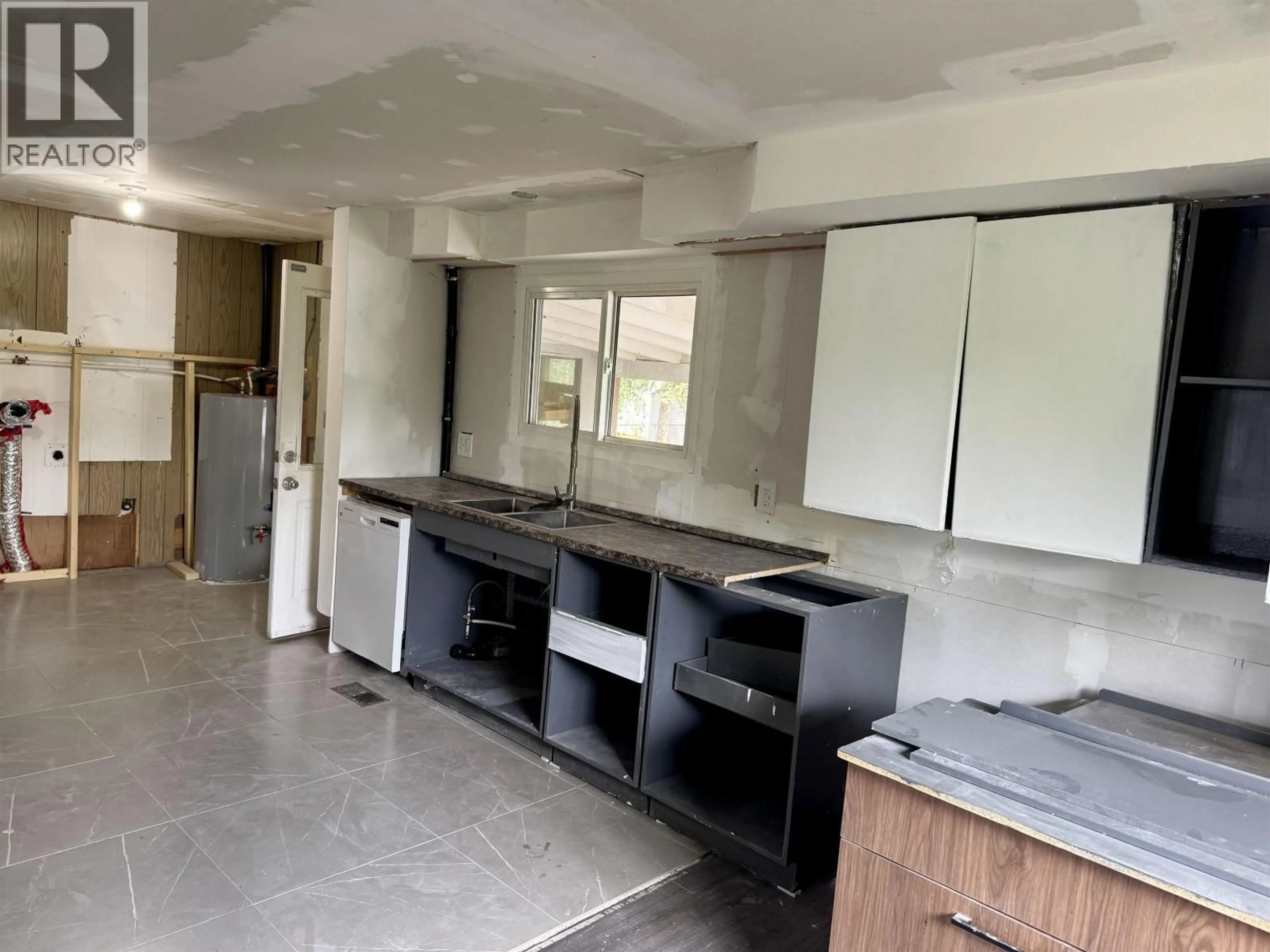 Kitchen with laundary machines, unknown for 204 3RD AVENUE, Fort St. James British Columbia V0J1P0