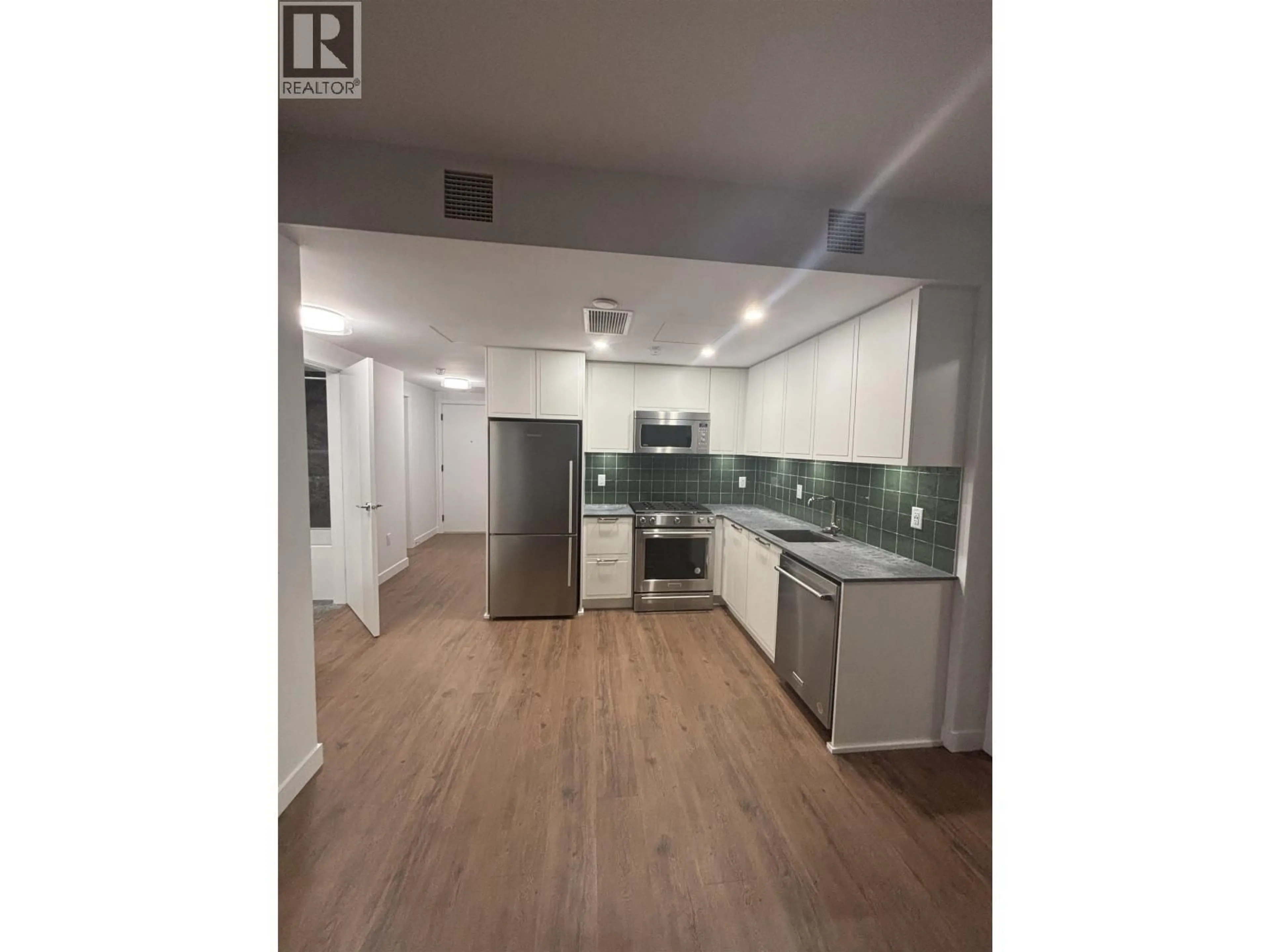 Open concept kitchen, wood/laminate floor for 414 - 645 COMO LAKE AVENUE, Coquitlam British Columbia V3J0N9