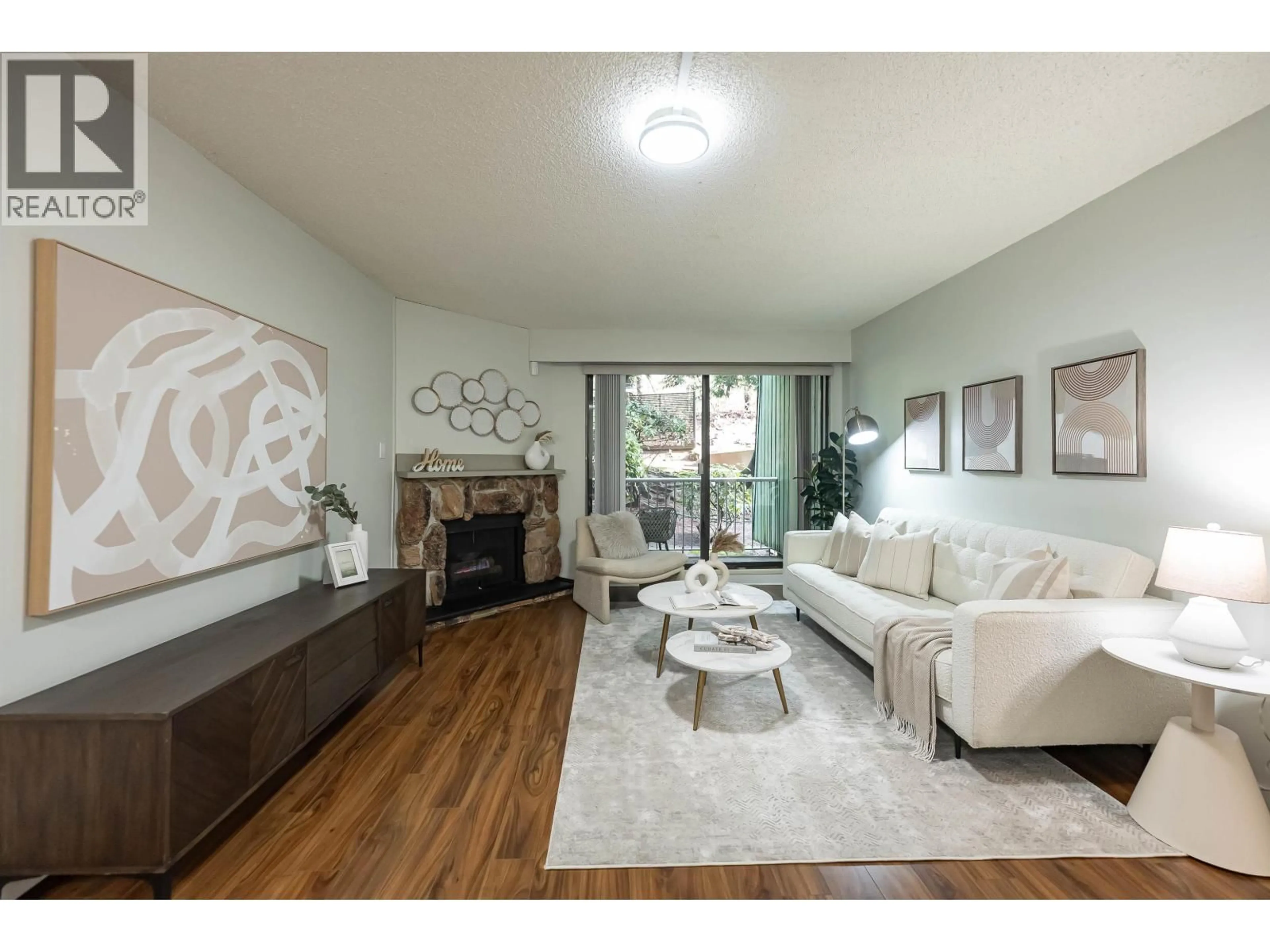 Living room with furniture, wood/laminate floor for 102 - 3901 CARRIGAN COURT, Burnaby British Columbia V3N4K1