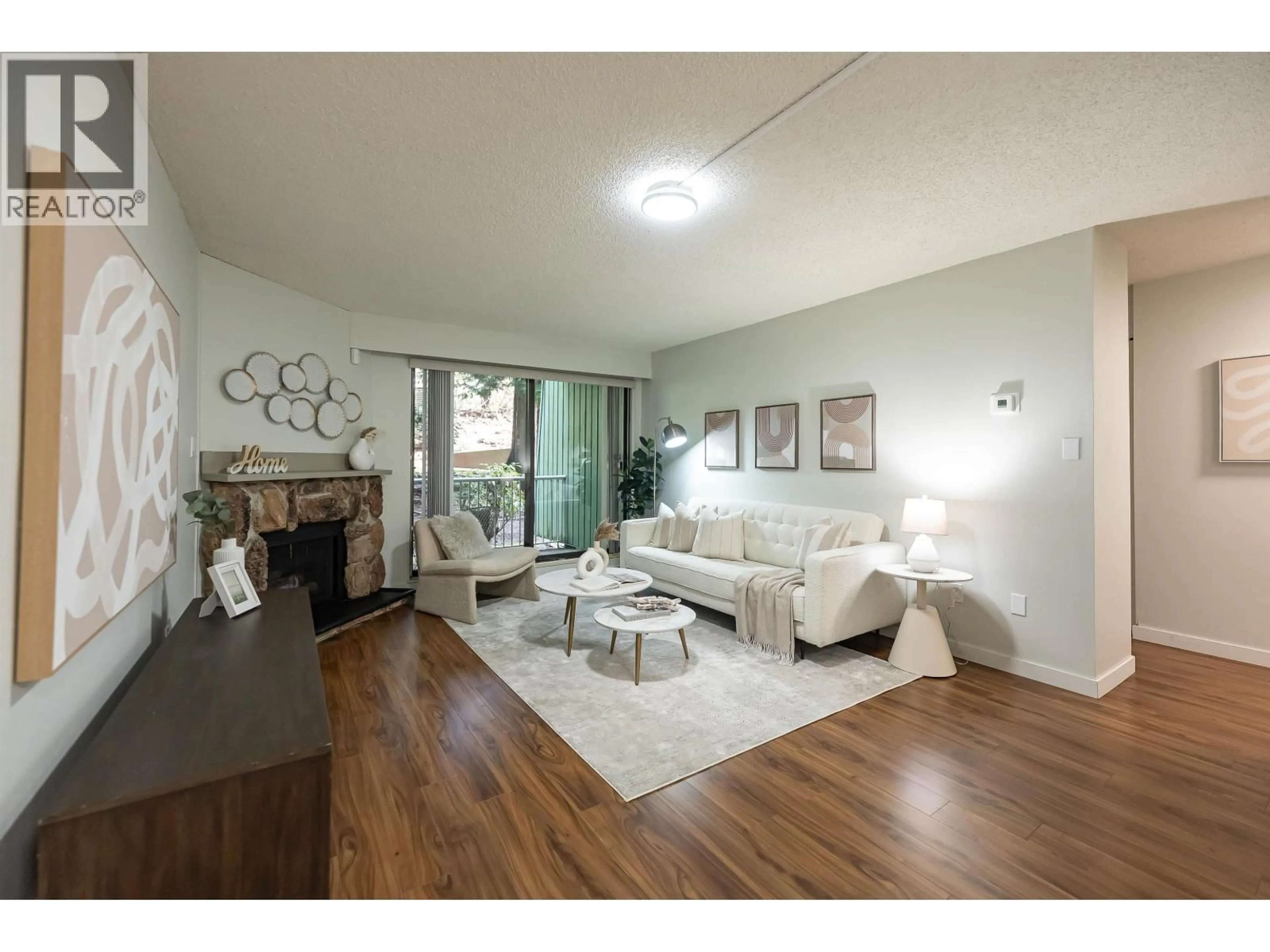Living room with furniture, wood/laminate floor for 102 - 3901 CARRIGAN COURT, Burnaby British Columbia V3N4K1