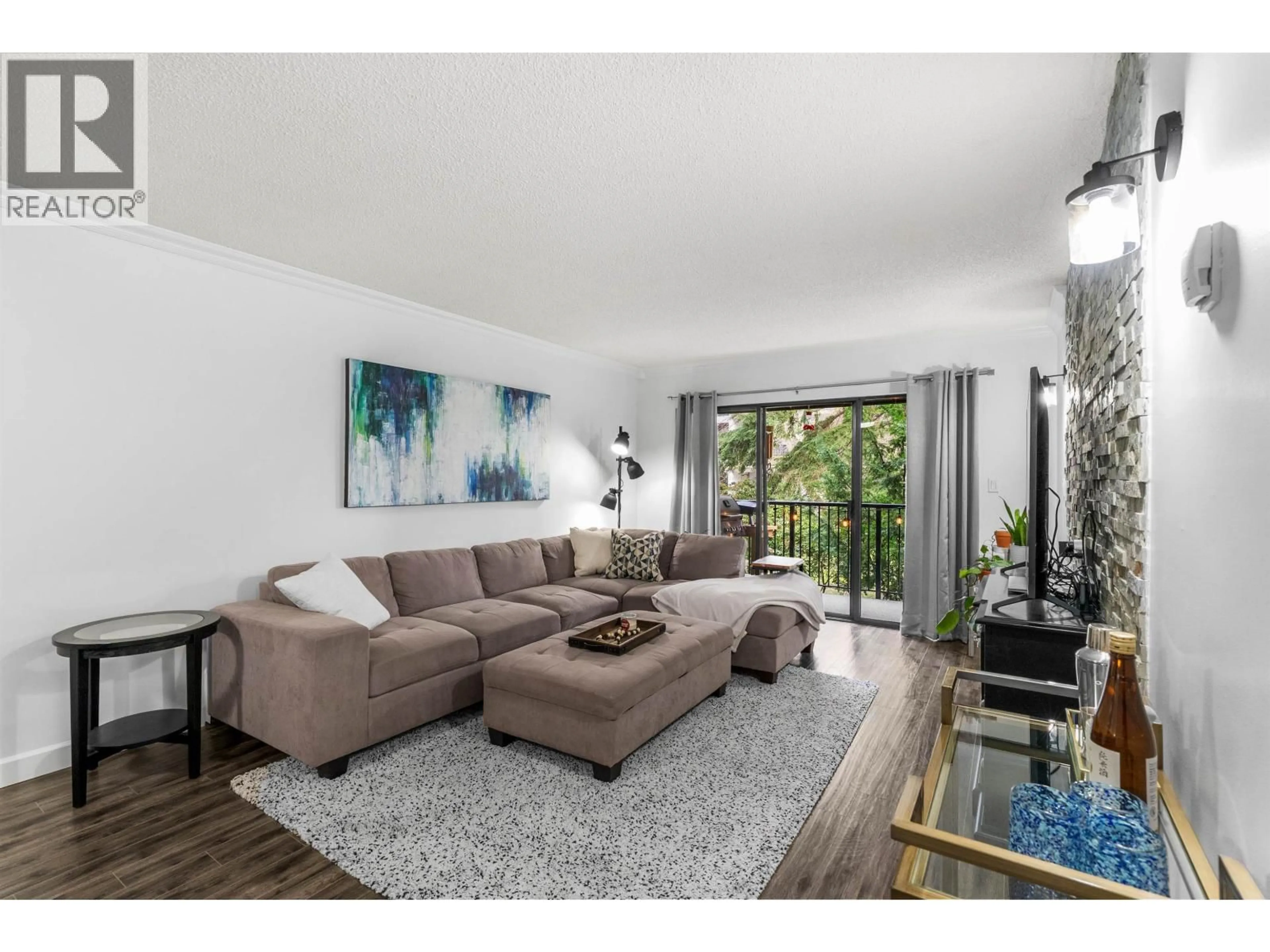 Living room with furniture, wood/laminate floor for 207 - 8840 NO 1 ROAD, Richmond British Columbia V7C4C1