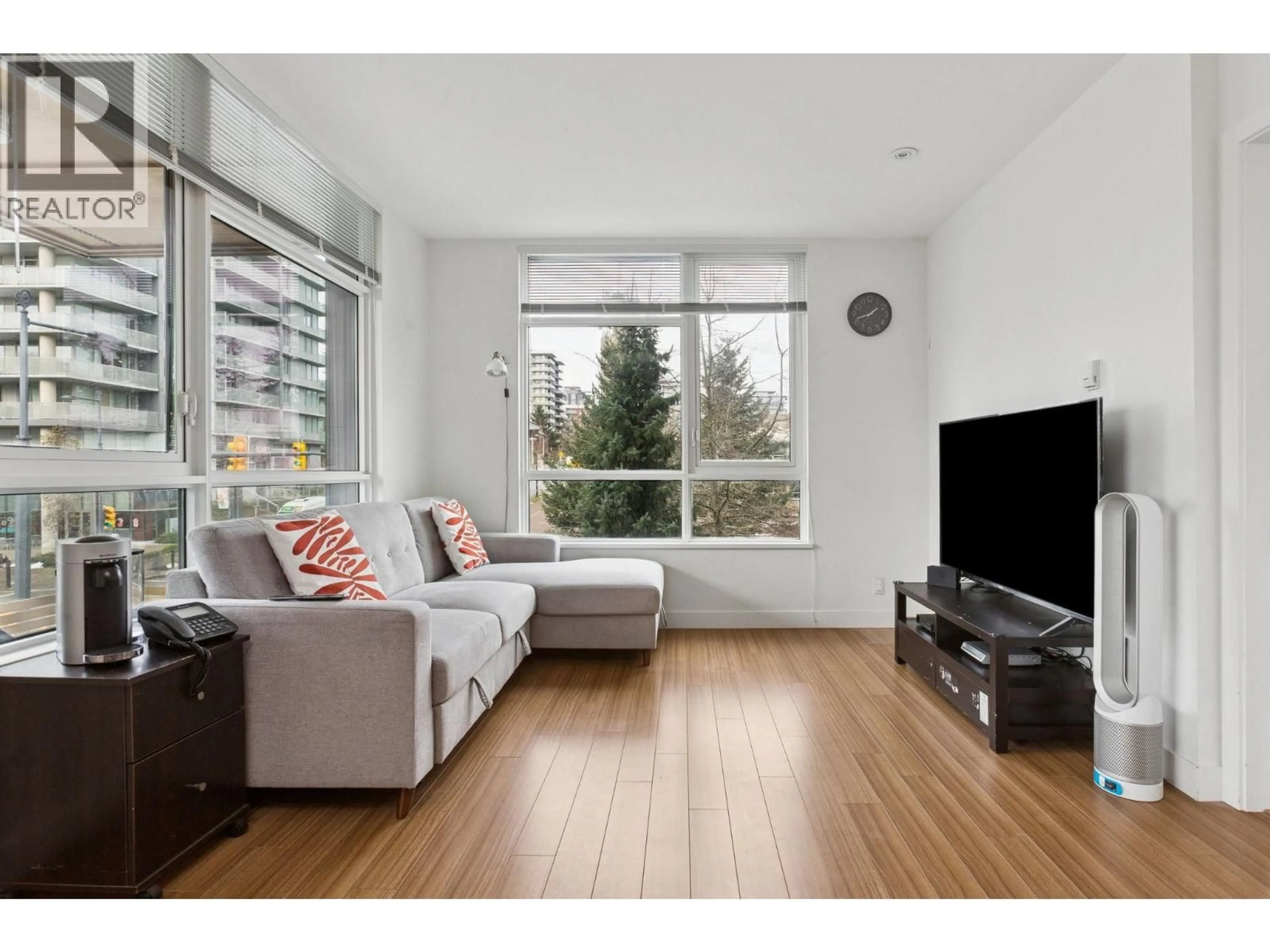 Living room with furniture, wood/laminate floor for 305 - 9150 UNIVERSITY HIGH STREET, Burnaby British Columbia V5A0C5