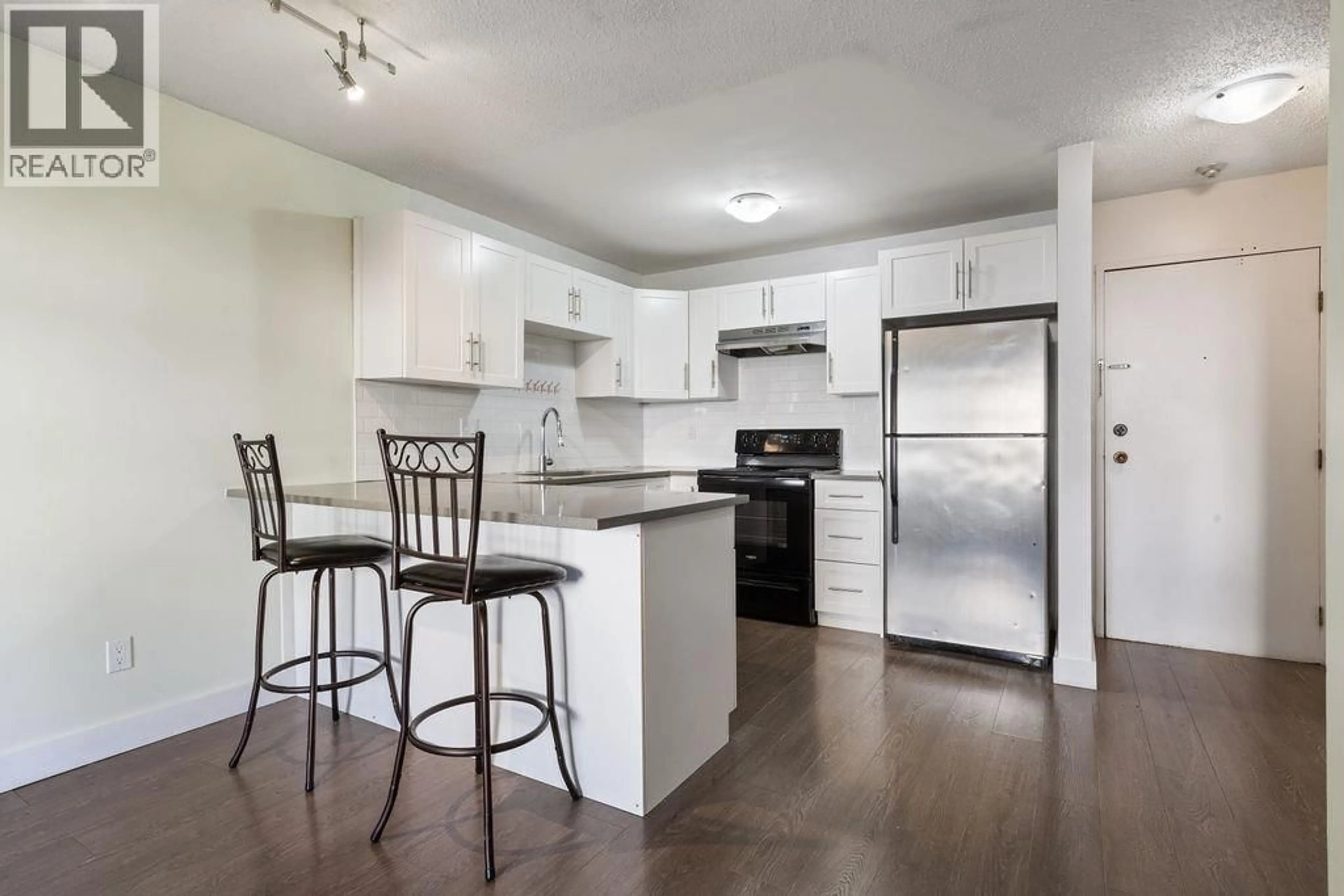 Open concept kitchen, wood/laminate floor for 204 - 1209 HOWIE AVENUE, Coquitlam British Columbia V3J1T9