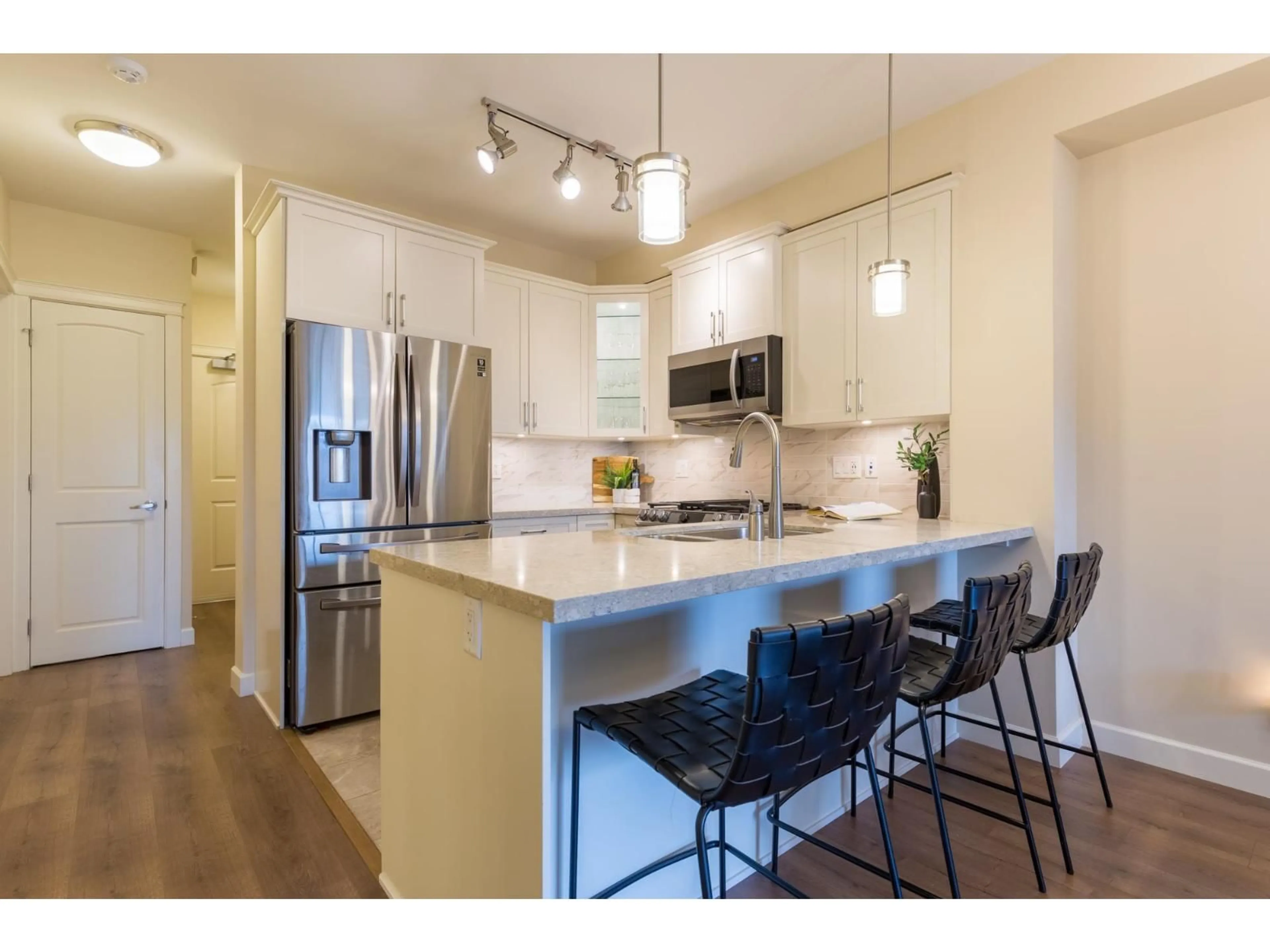 Open concept kitchen, wood/laminate floor for 311 - 8561 203A STREET, Langley British Columbia V2Y3L7