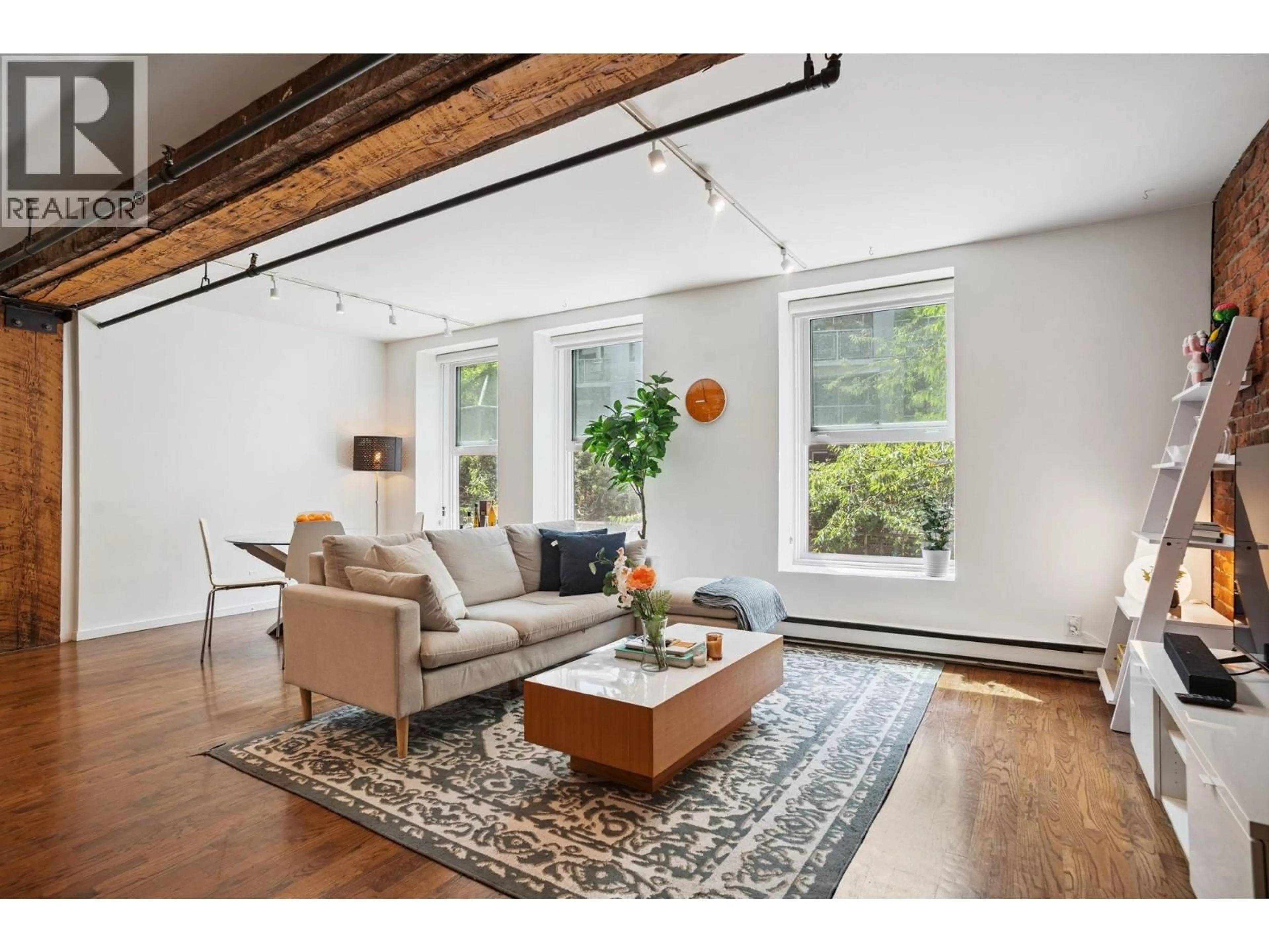 Living room with furniture, wood/laminate floor for 203 - 150 ALEXANDER STREET, Vancouver British Columbia V6A1B5