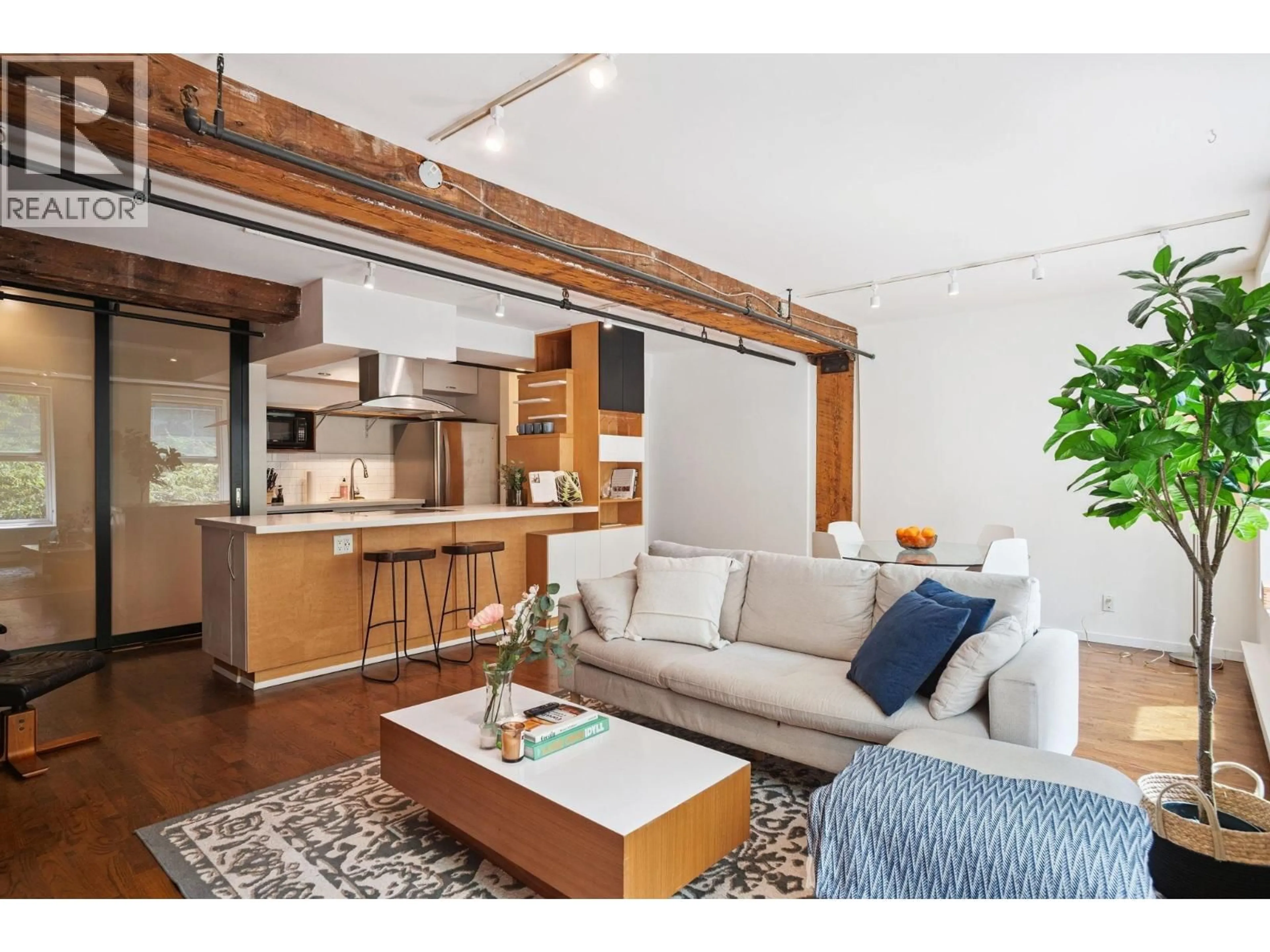 Living room with furniture, wood/laminate floor for 203 - 150 ALEXANDER STREET, Vancouver British Columbia V6A1B5