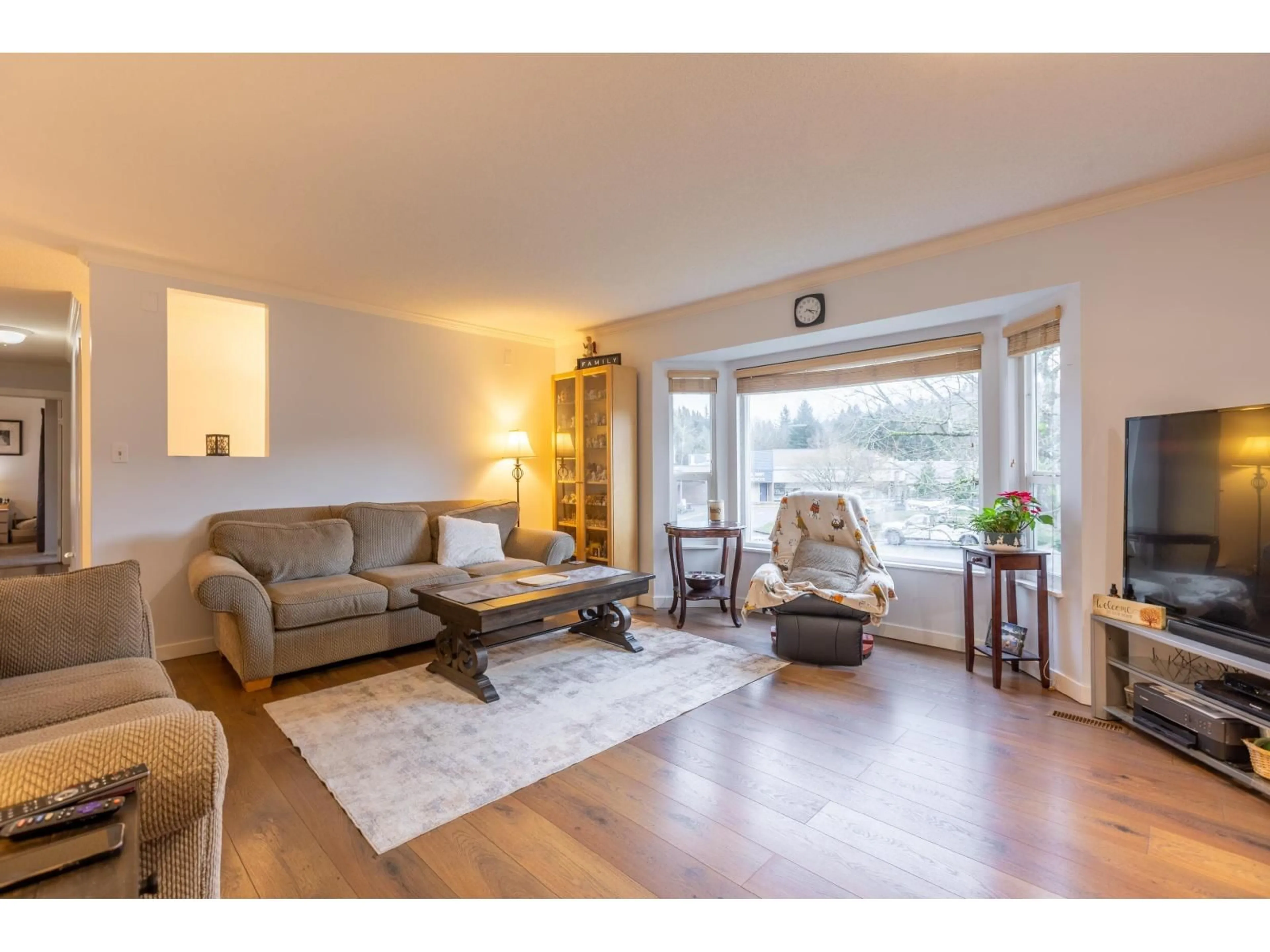 Living room with furniture, wood/laminate floor for 34787 MIERAU STREET, Abbotsford British Columbia V2S5Y3