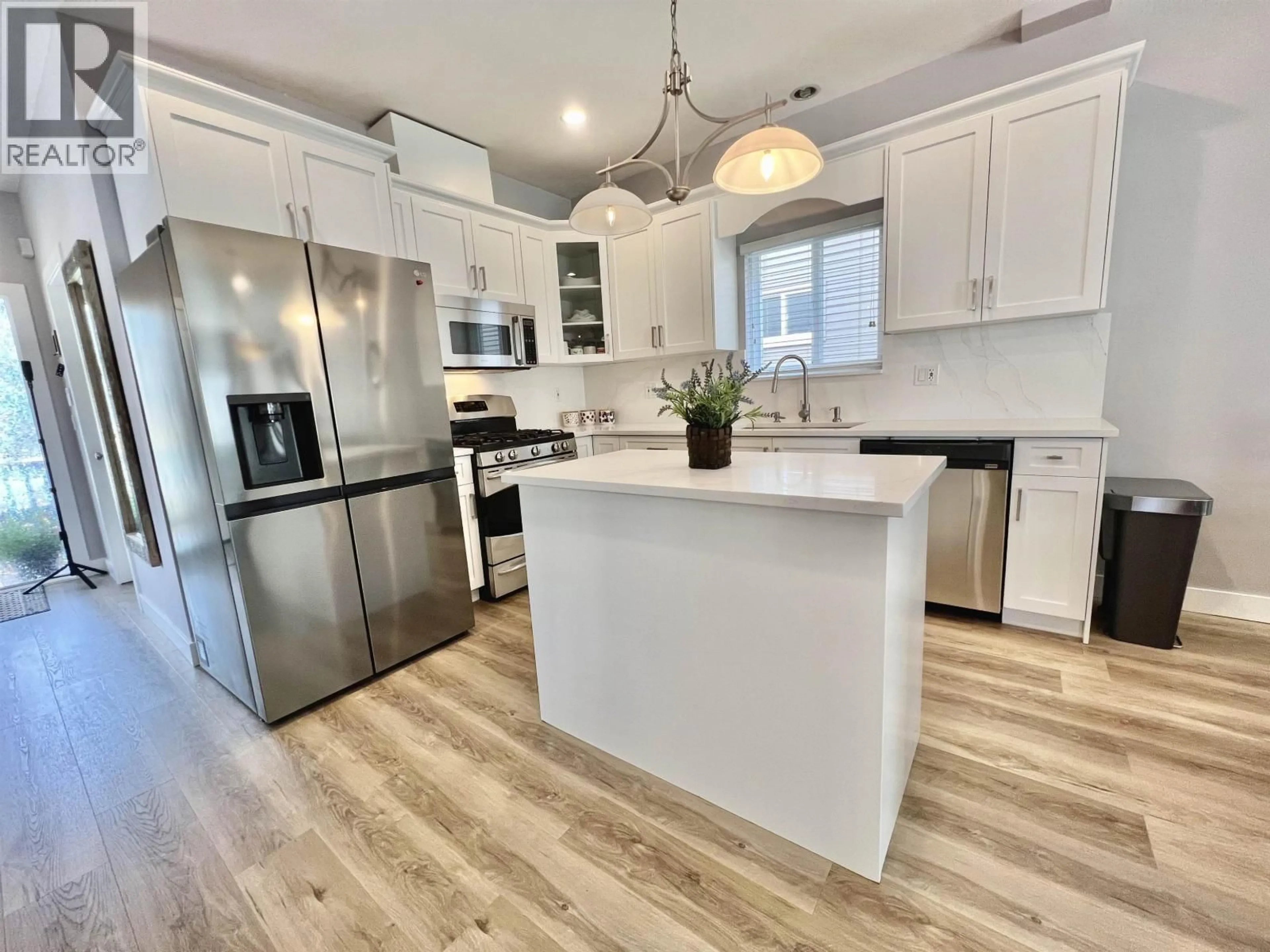 Open concept kitchen, wood/laminate floor for 24282 101A AVENUE, Maple Ridge British Columbia V2W0C2