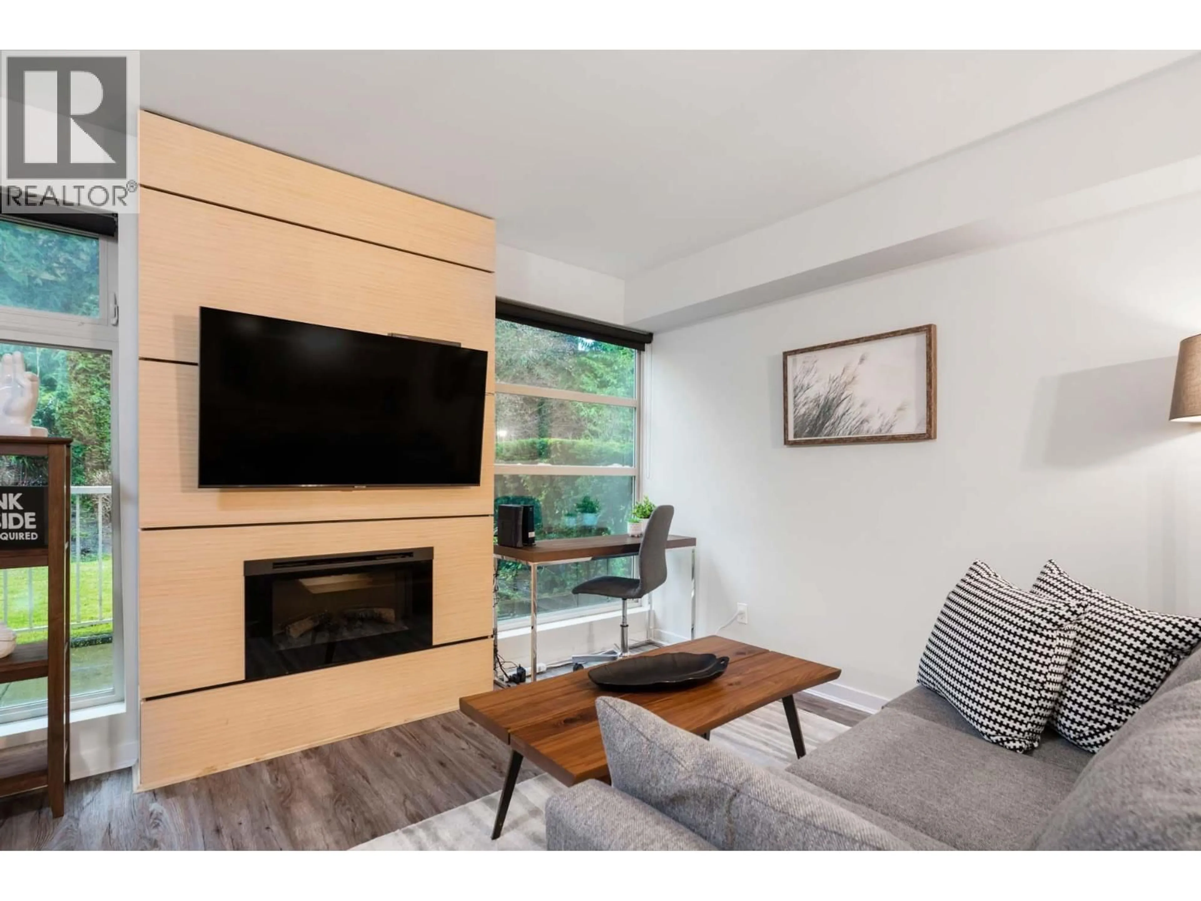 Living room with furniture, wood/laminate floor for 104 - 2832 CAPILANO ROAD, North Vancouver British Columbia V7R4H5