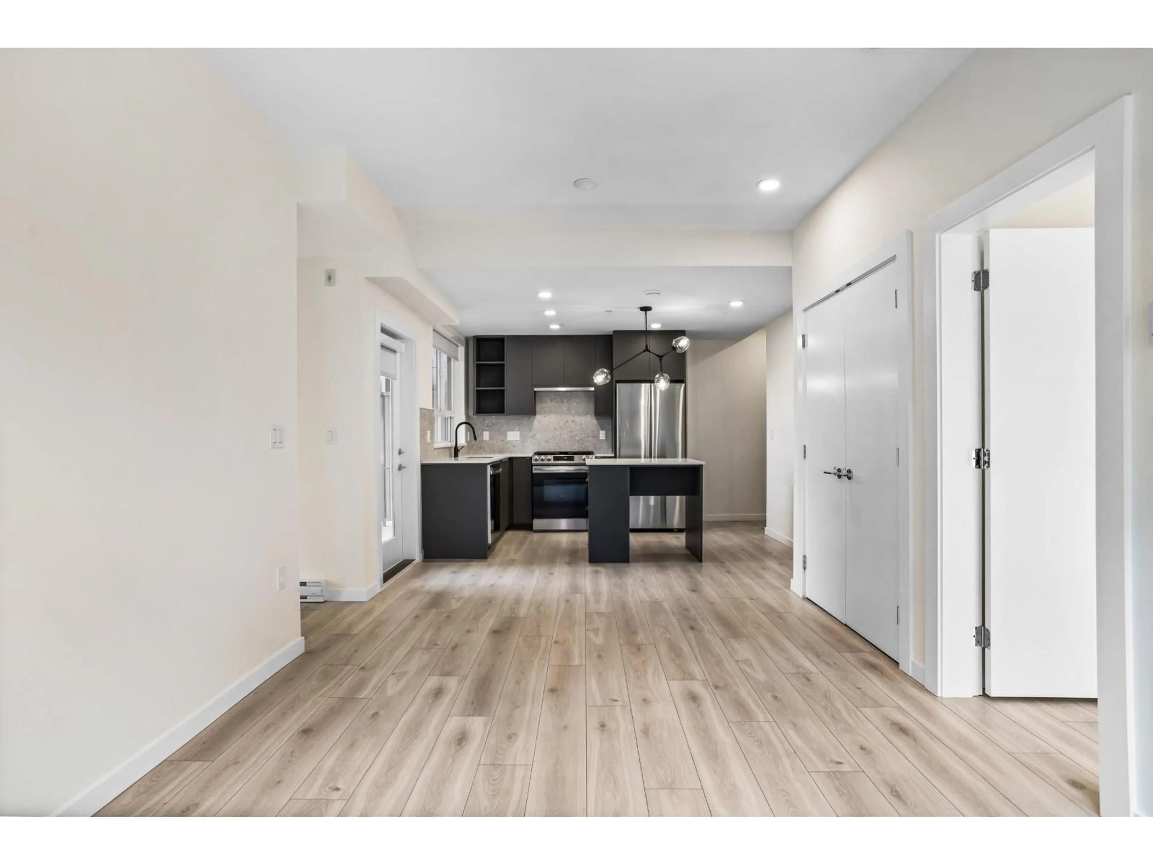 Open concept kitchen, wood/laminate floor for 301 - 7920 206 STREET, Langley British Columbia V3A8S5