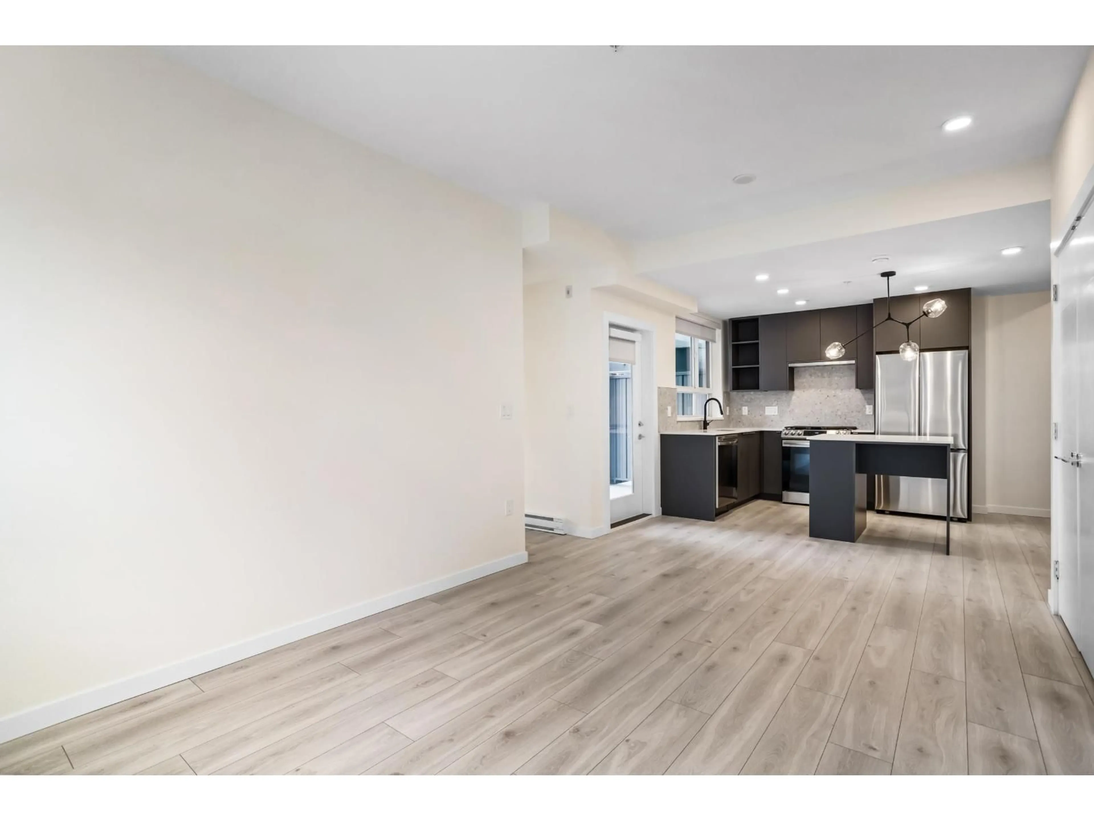 Open concept kitchen, wood/laminate floor for 301 - 7920 206 STREET, Langley British Columbia V3A8S5