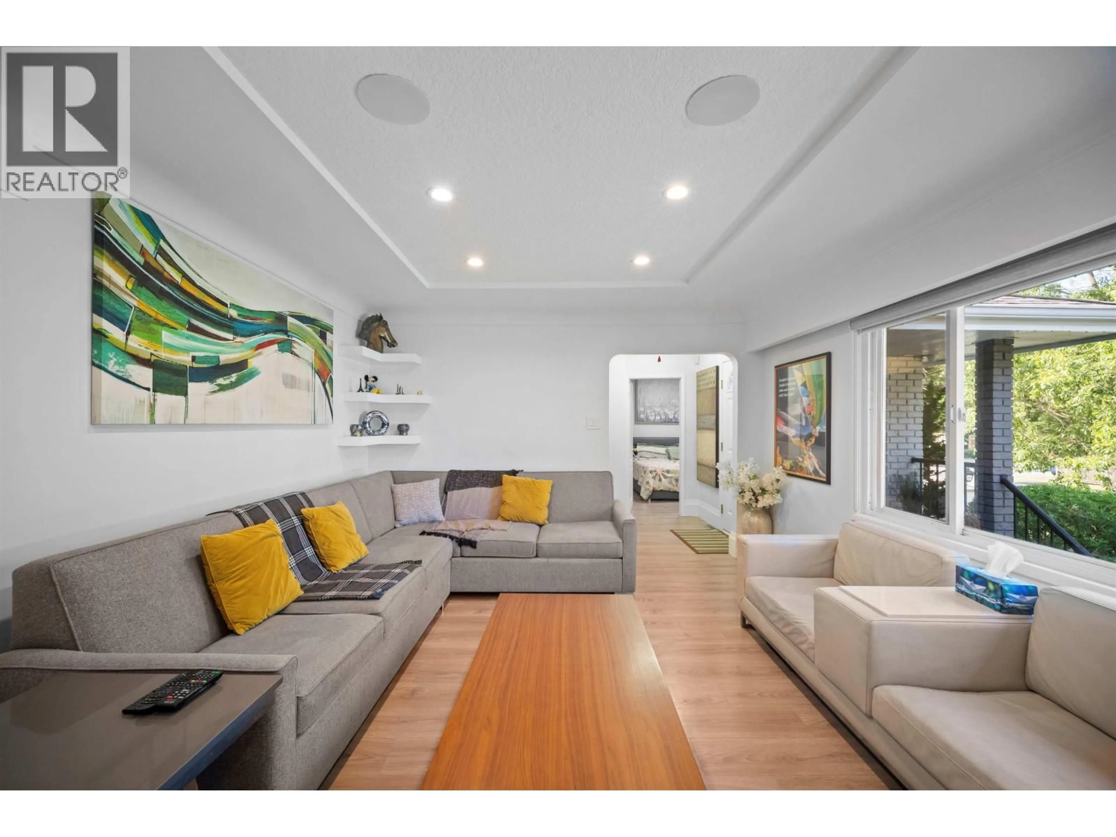 Living room with furniture, wood/laminate floor for 6978 MCKINNON STREET, Vancouver British Columbia V5S3G5