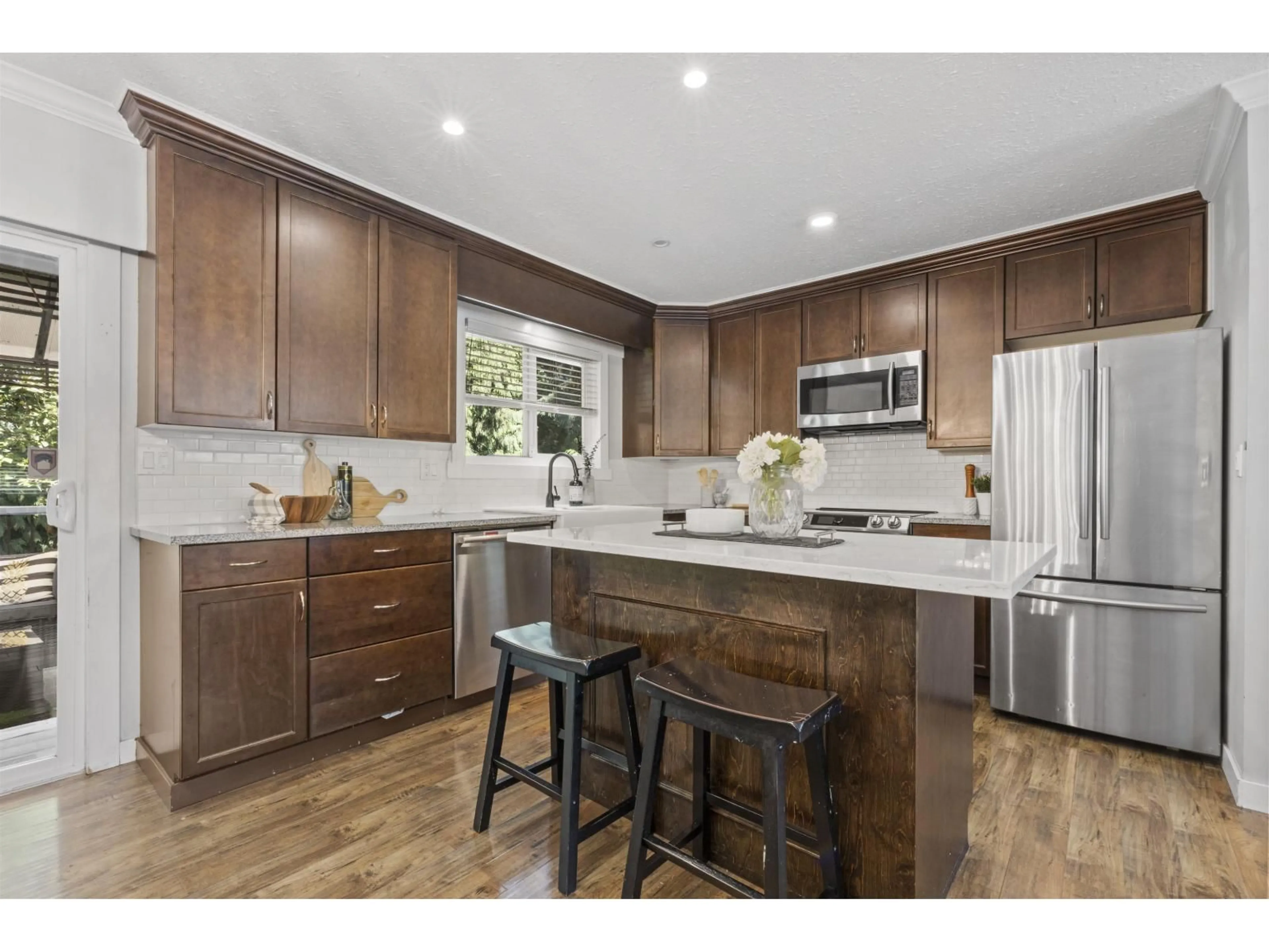 Open concept kitchen, wood/laminate floor for 19745 38A AVENUE, Langley British Columbia V3A4W7