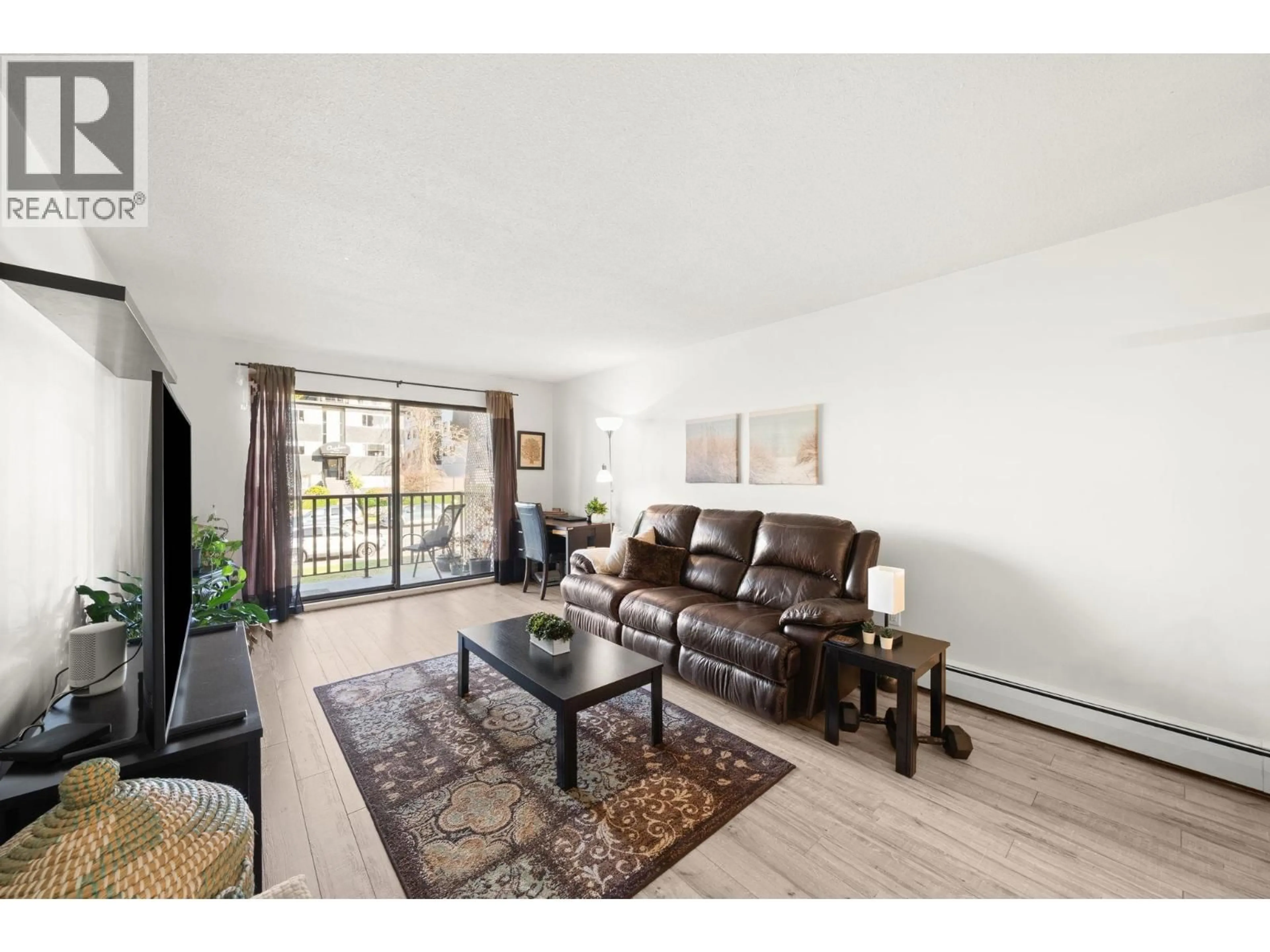 Living room with furniture, wood/laminate floor for 203 - 131 4TH STREET, North Vancouver British Columbia V7M3C8