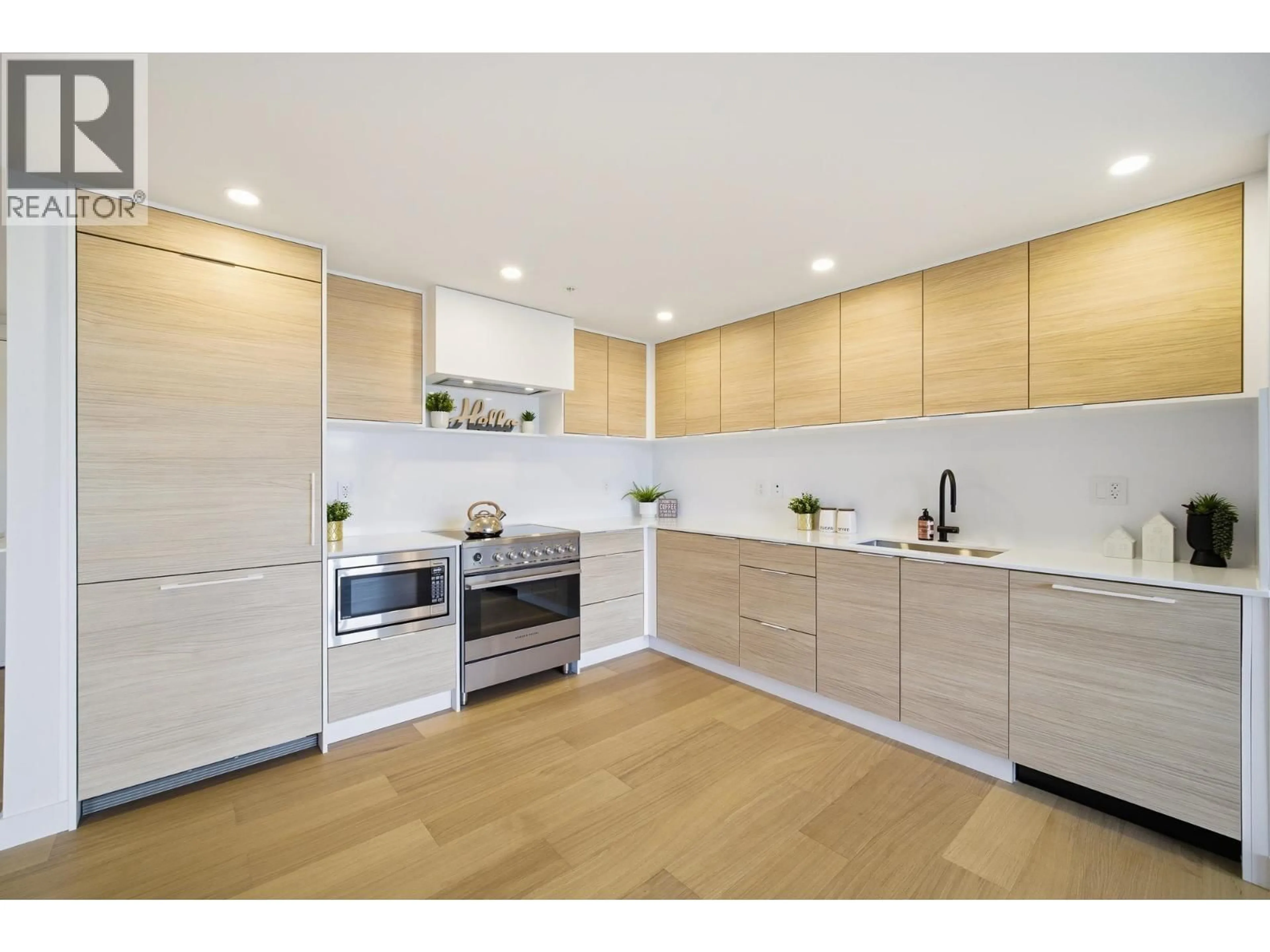 Open concept kitchen, wood/laminate floor for 406 - 6485 MANITOBA STREET, Vancouver British Columbia V5Y0P7