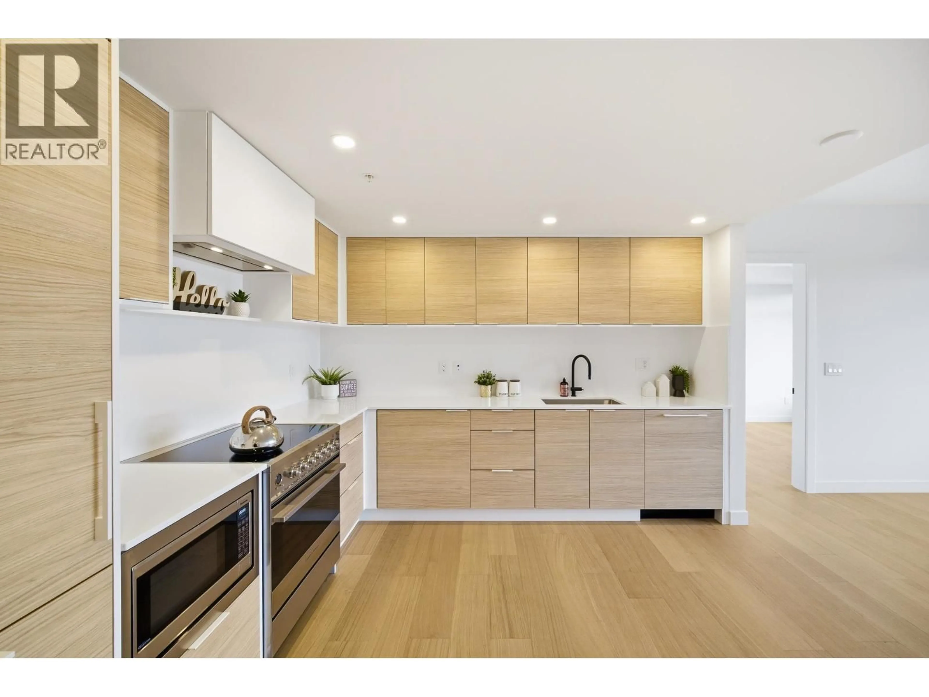 Contemporary kitchen, wood/laminate floor for 406 - 6485 MANITOBA STREET, Vancouver British Columbia V5Y0P7