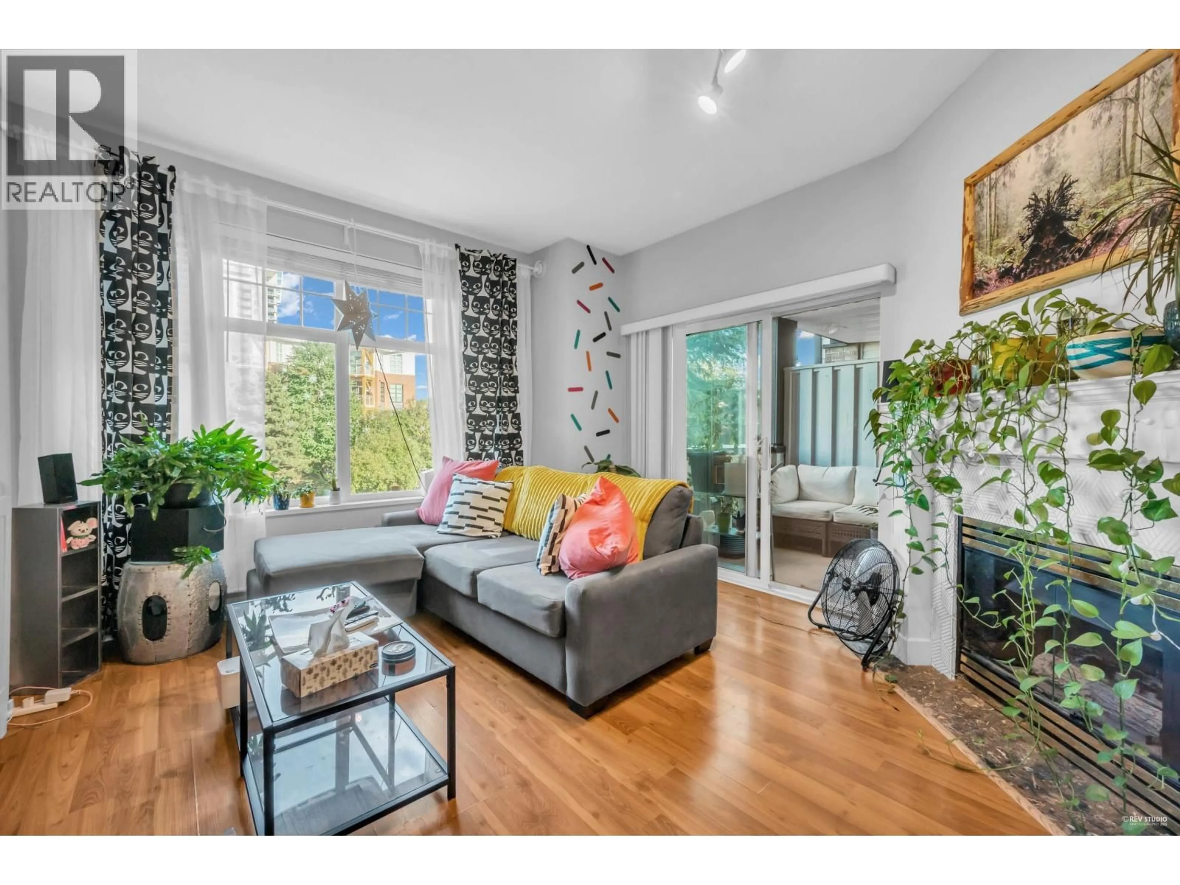 Living room with furniture, wood/laminate floor for 213 - 83 STAR CRESCENT, New Westminster British Columbia V3M6X8