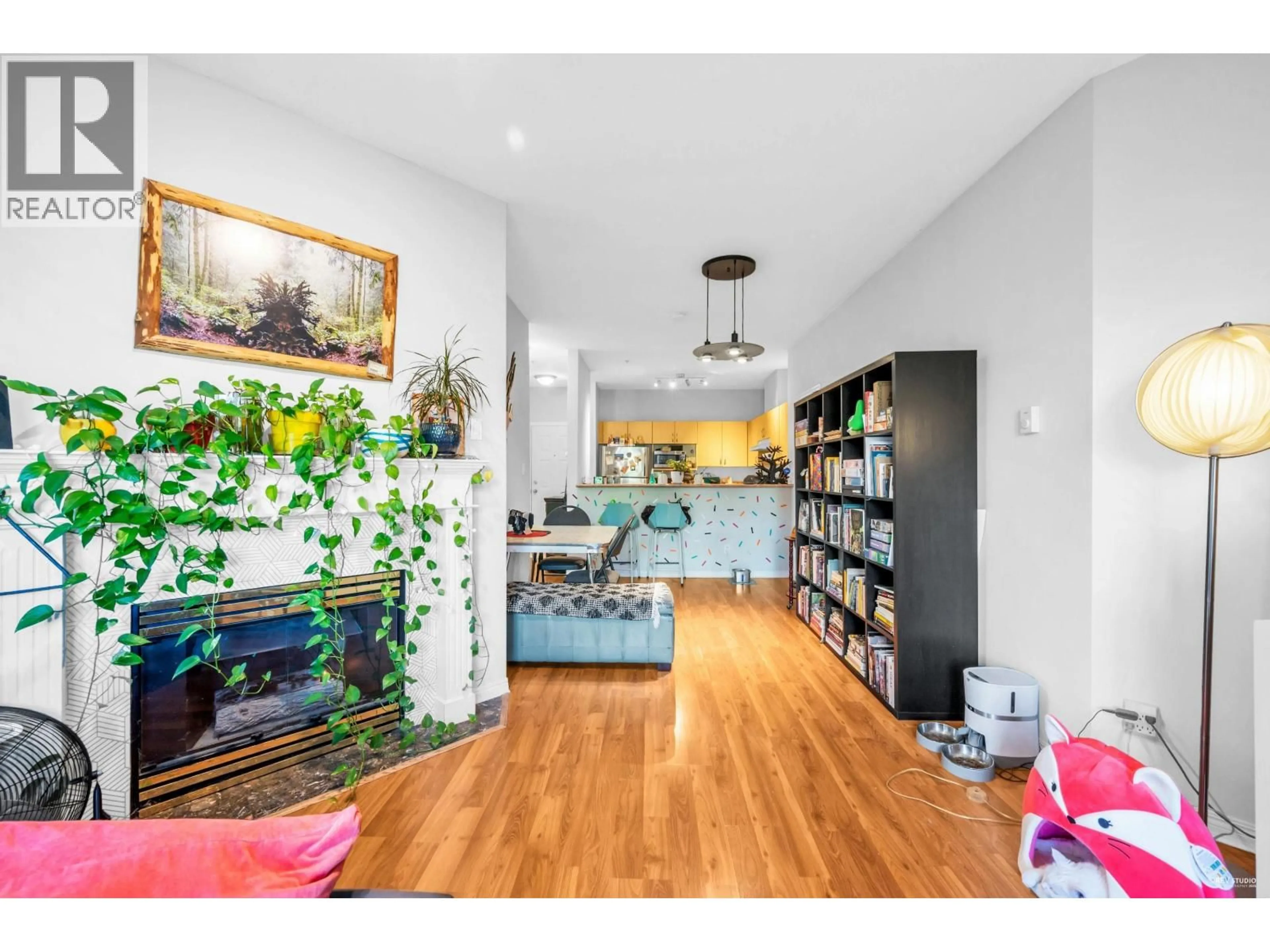 Living room with furniture, wood/laminate floor for 213 - 83 STAR CRESCENT, New Westminster British Columbia V3M6X8