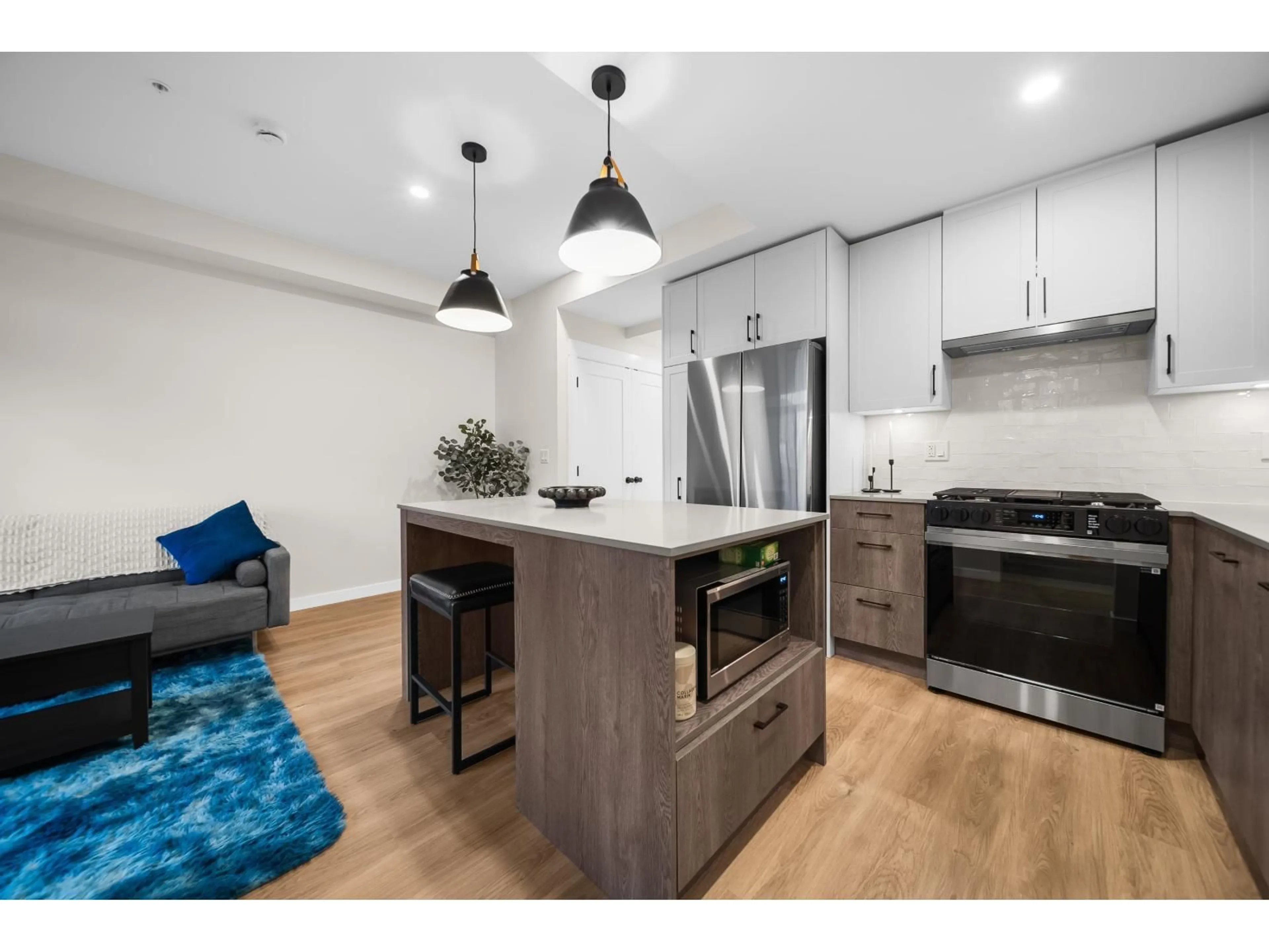 Open concept kitchen, wood/laminate floor for 201 - 27218 ALDERGROVE TOWN CENTRE DRIVE, Langley British Columbia V4W0E2