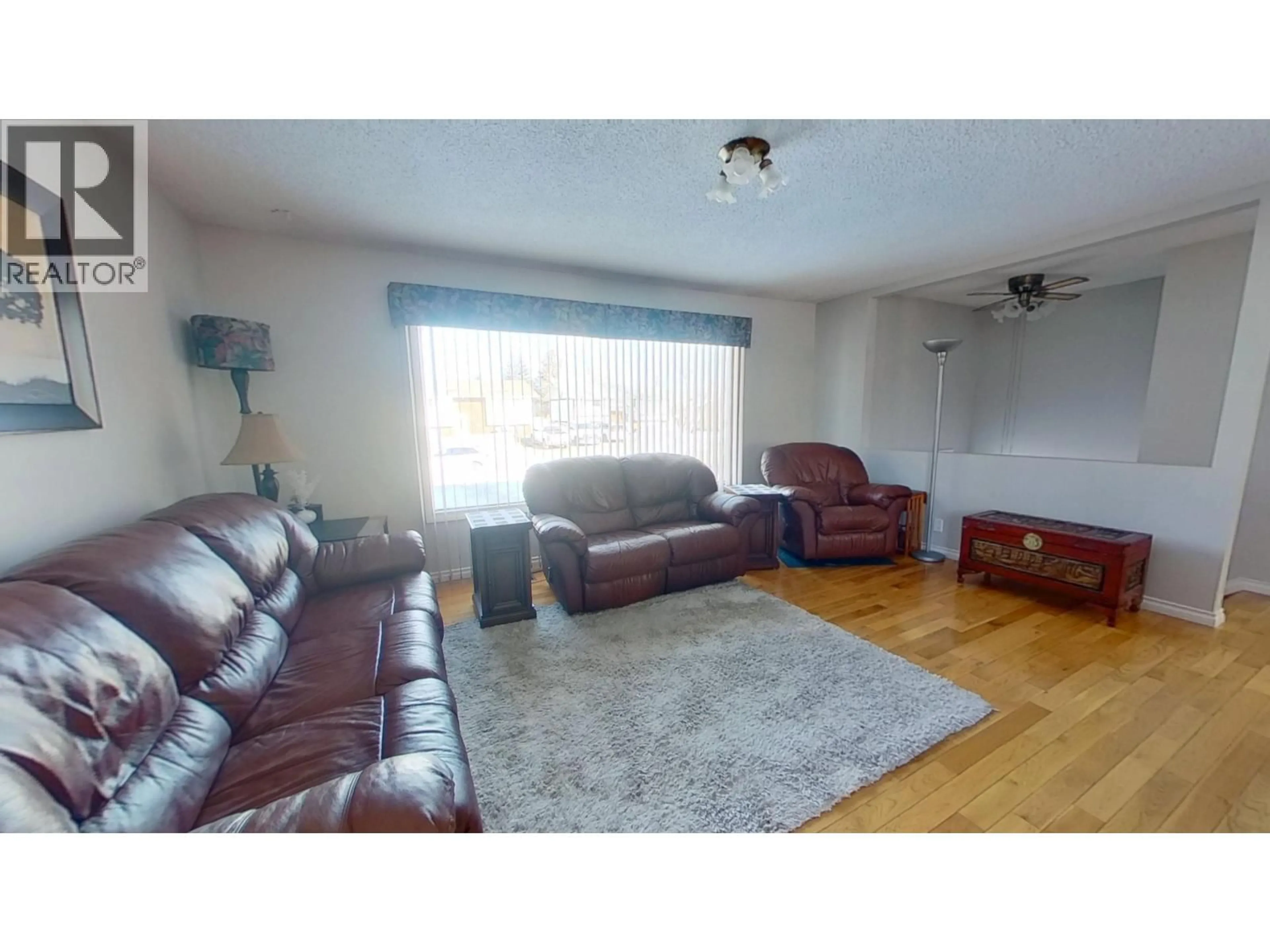 Living room with furniture, wood/laminate floor for 9507 104 AVENUE, Fort St. John British Columbia V1J2J8