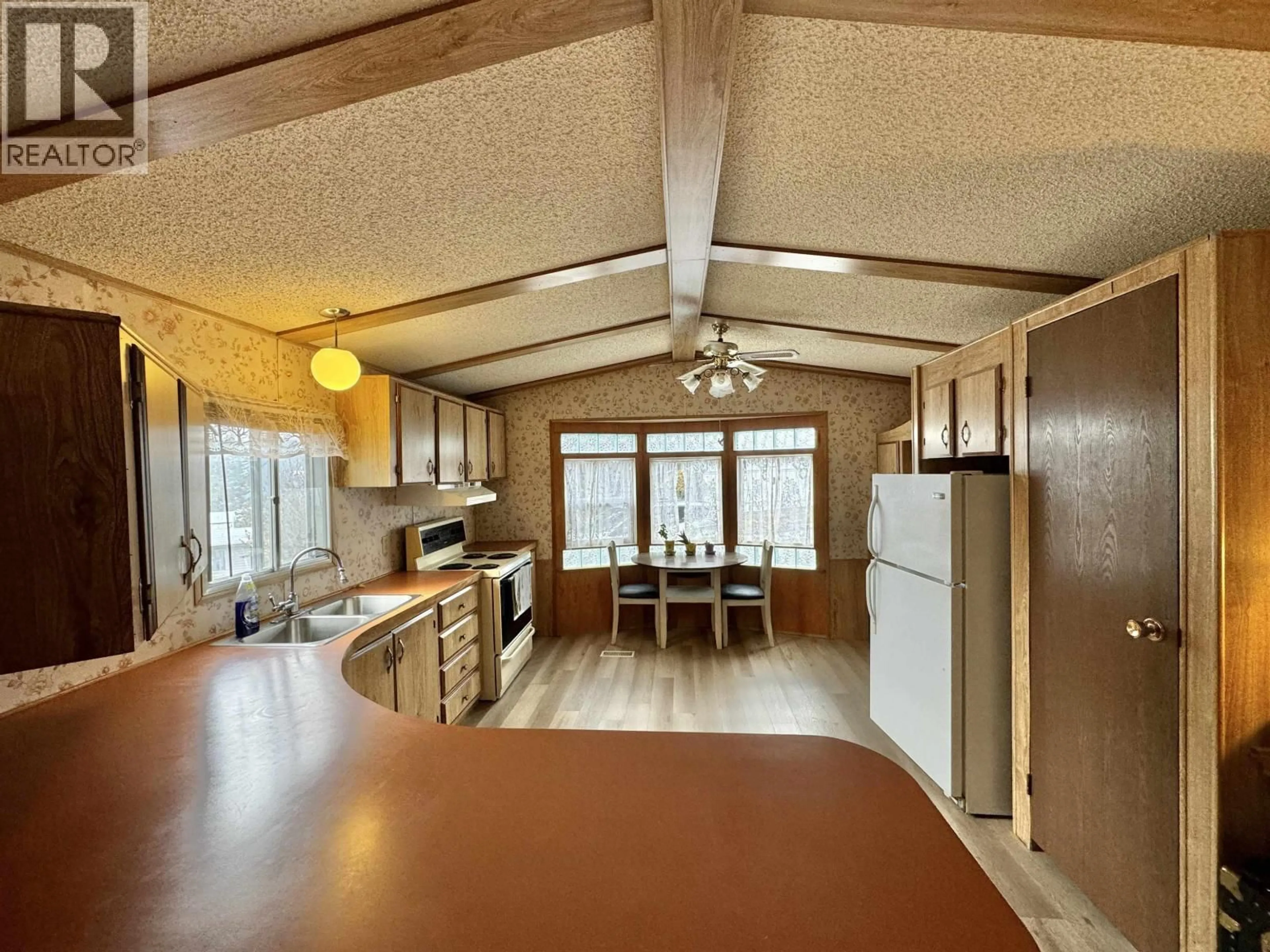 Open concept kitchen, wood/laminate floor for 54 - 770 11TH AVENUE, Williams Lake British Columbia V2G2M4
