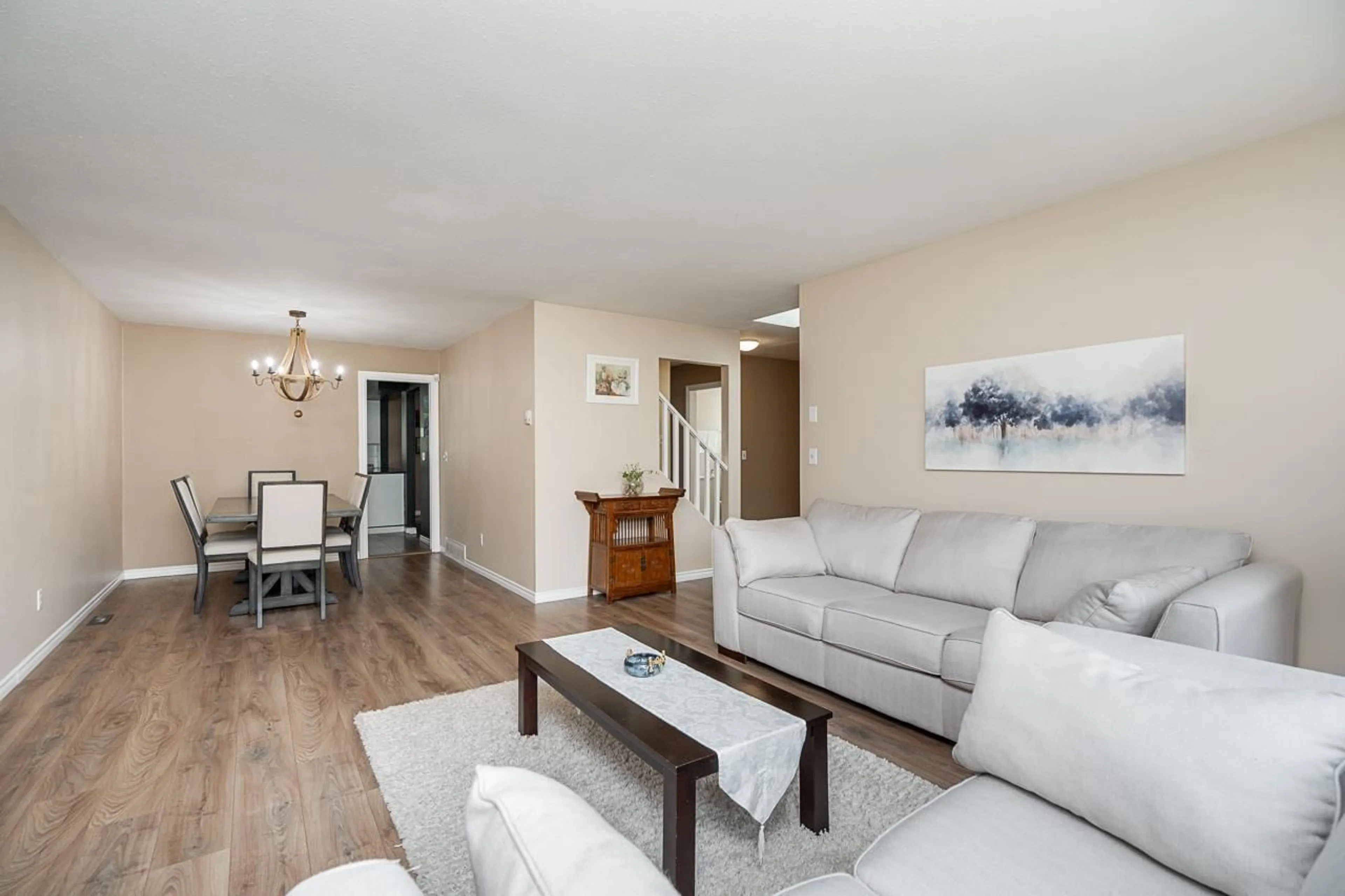 Living room with furniture, wood/laminate floor for 15478 90 AVENUE, Surrey British Columbia V3R9J4