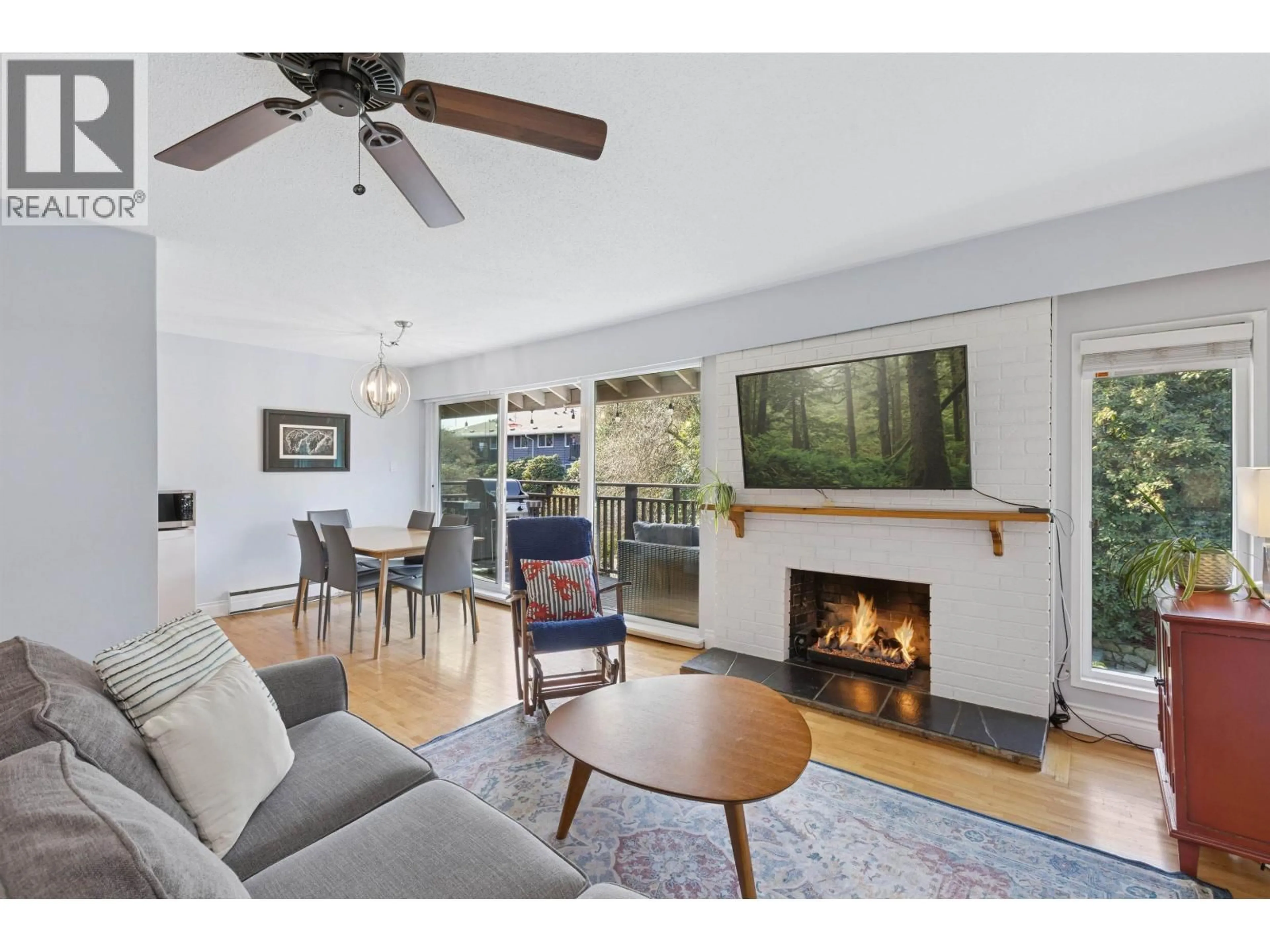 Living room with furniture, wood/laminate floor for 214 - 555 28TH STREET, North Vancouver British Columbia V7N2J7