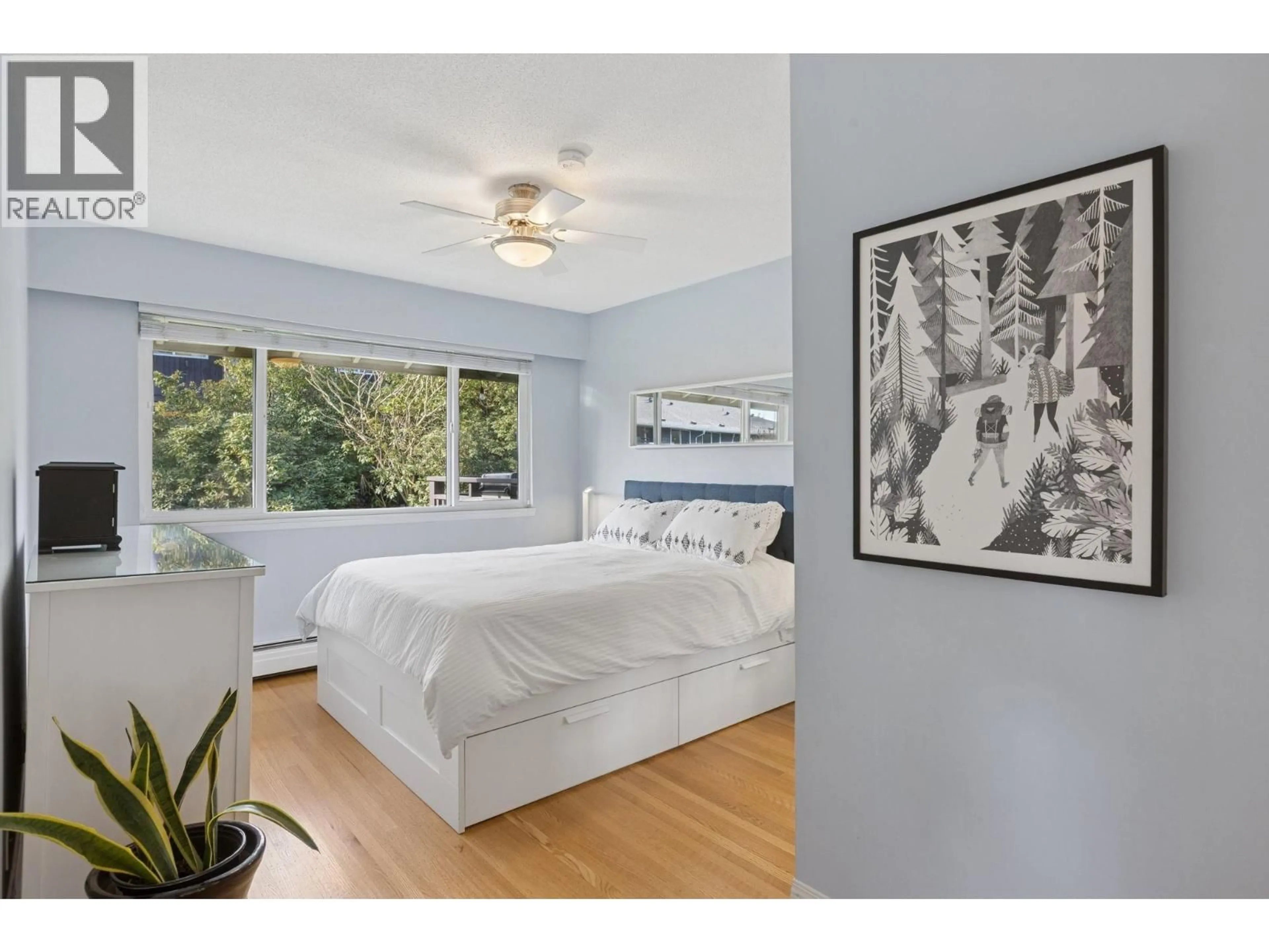 Bedroom with bed, wood/laminate floor for 214 - 555 28TH STREET, North Vancouver British Columbia V7N2J7