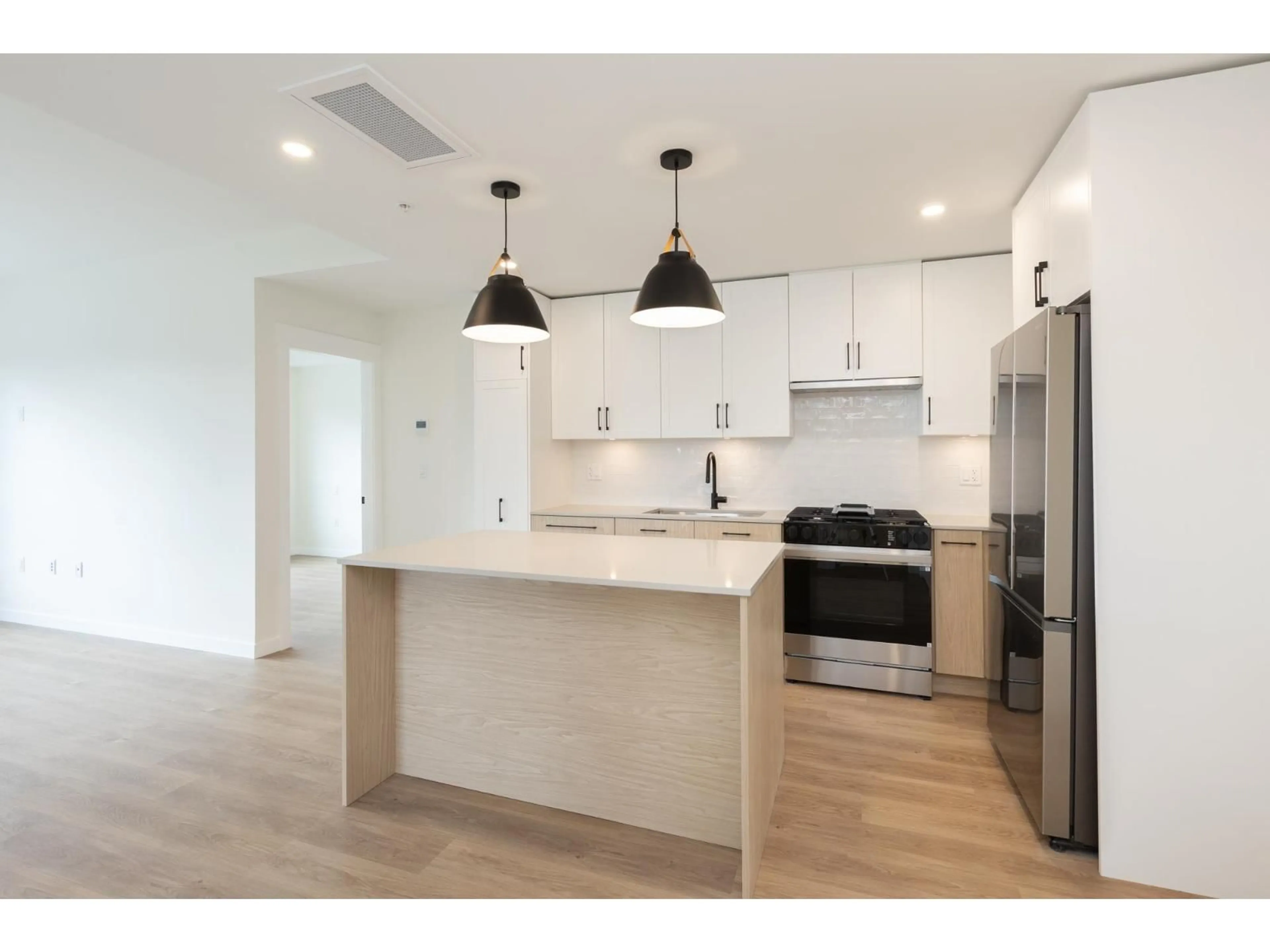 Open concept kitchen, wood/laminate floor for 305 - 27249 ALDERGROVE TOWN CENTRE DRIVE, Langley British Columbia V4W0E4