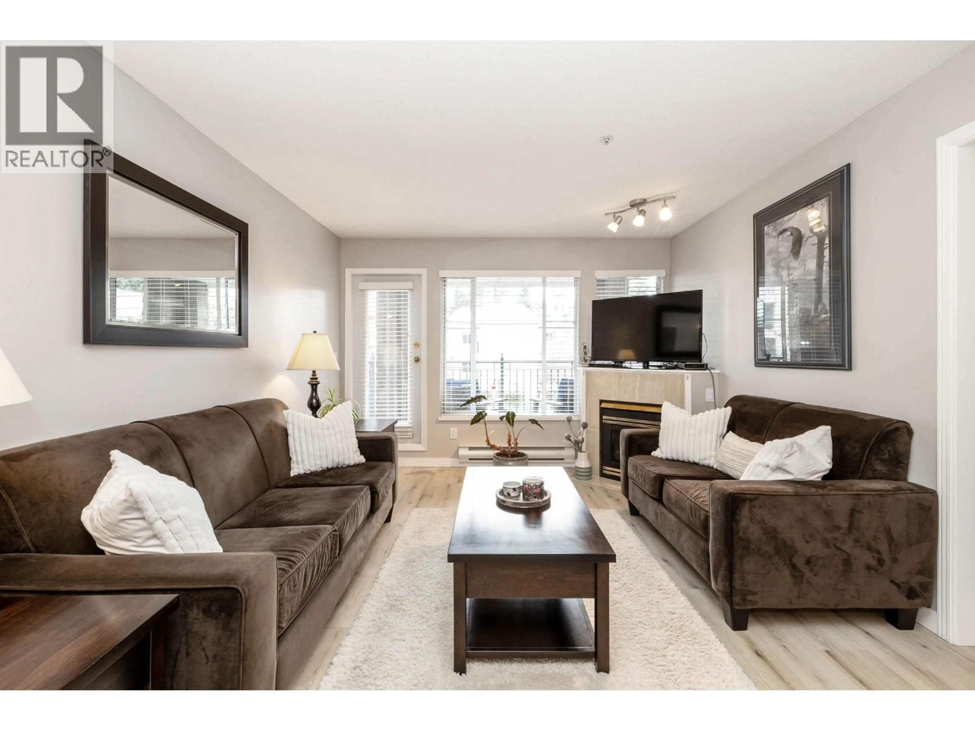 Living room with furniture, wood/laminate floor for 304 - 3065 PRIMROSE LANE, Coquitlam British Columbia V3B7P7