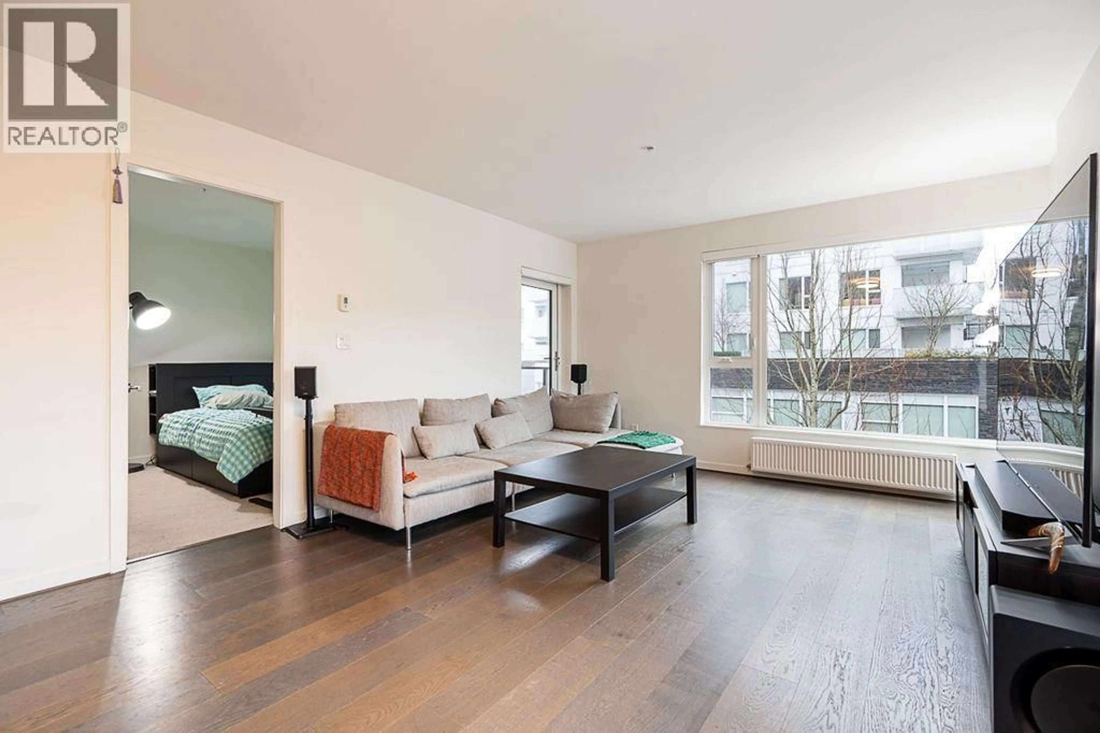 Living room with furniture, wood/laminate floor for 520 - 5955 BIRNEY AVENUE, Vancouver British Columbia V6S0C5