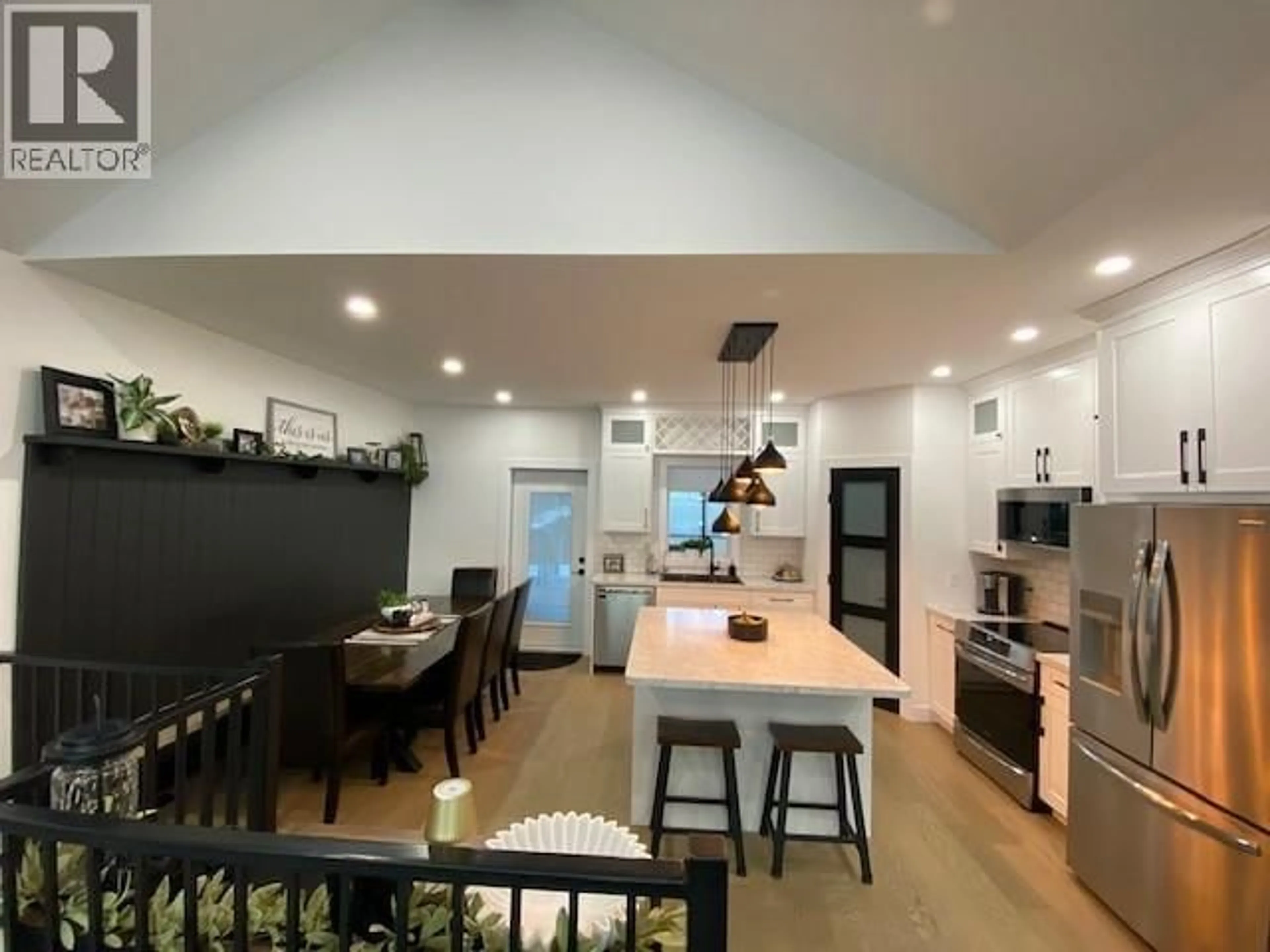 Open concept kitchen, wood/laminate floor for 11212 114 AVENUE, Fort St. John British Columbia V1J0R5