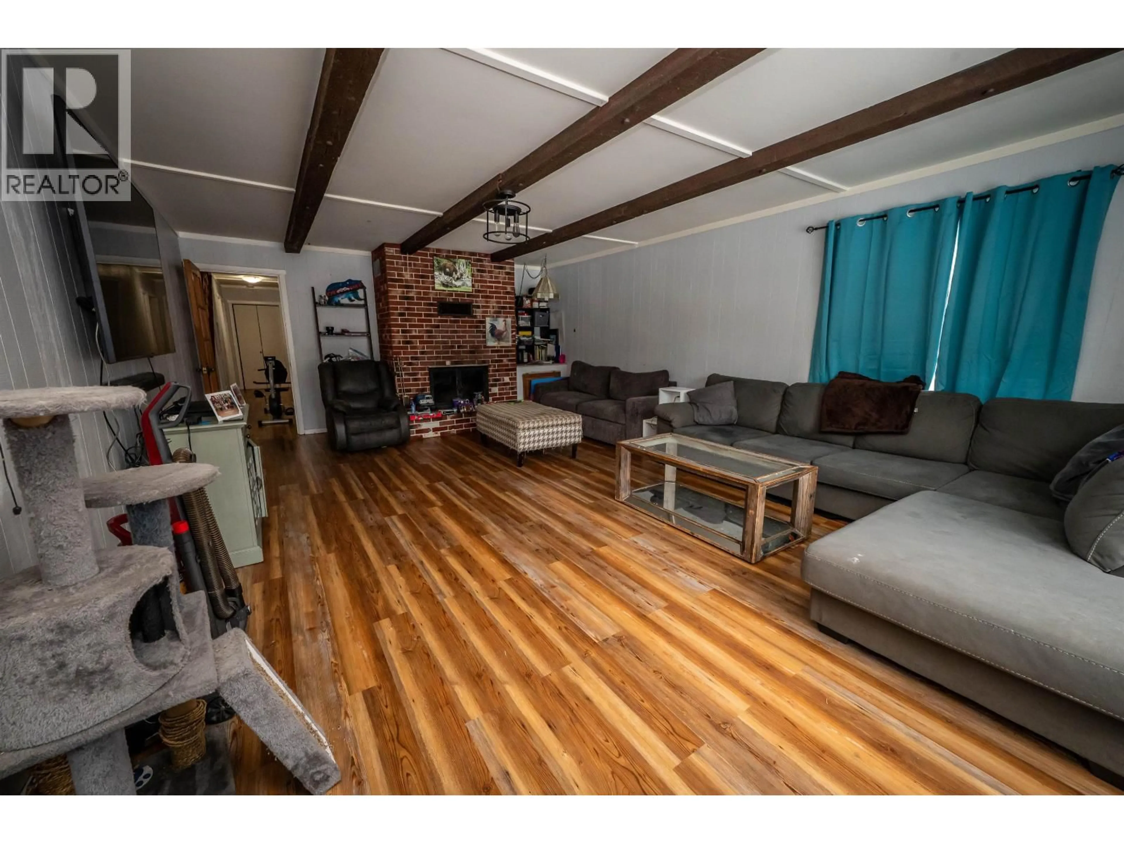 Living room with furniture, wood/laminate floor for 1650 COYOTE ROAD, Williams Lake British Columbia V2G4X8