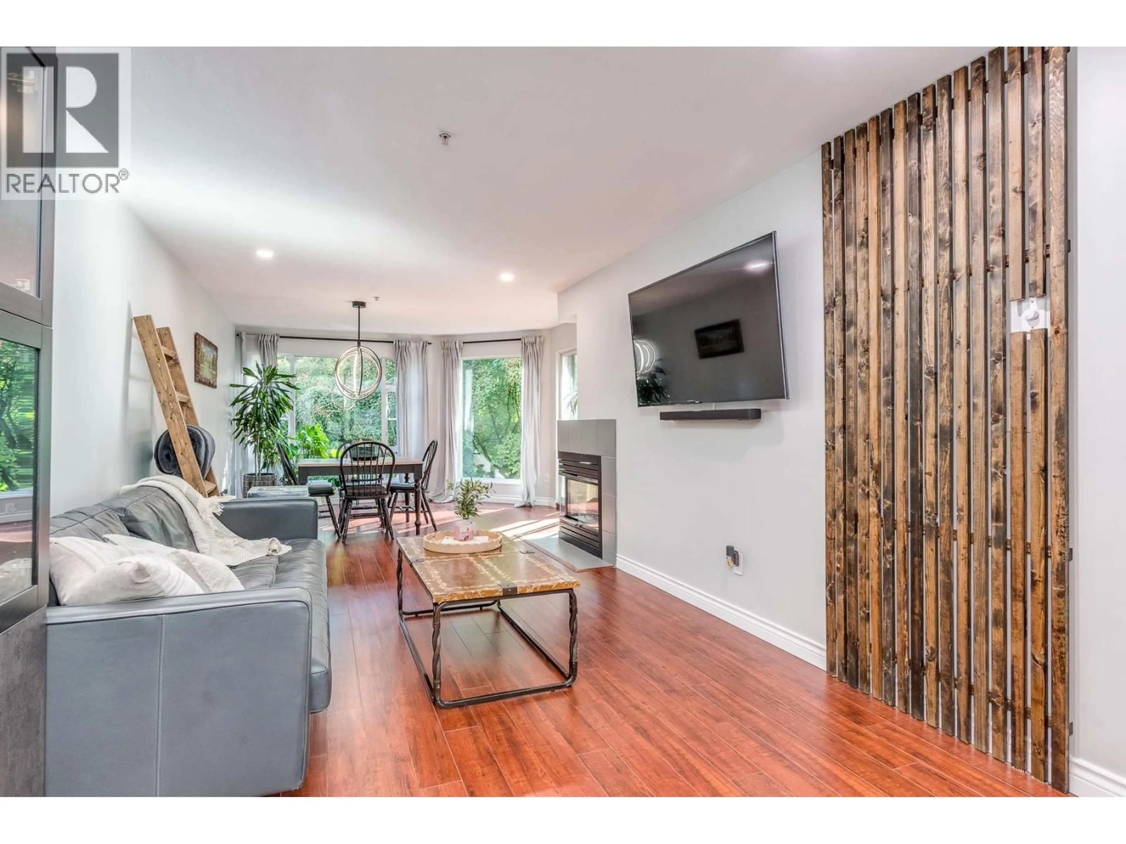 Living room with furniture, wood/laminate floor for 212 - 22233 RIVER ROAD, Maple Ridge British Columbia V2X3N7