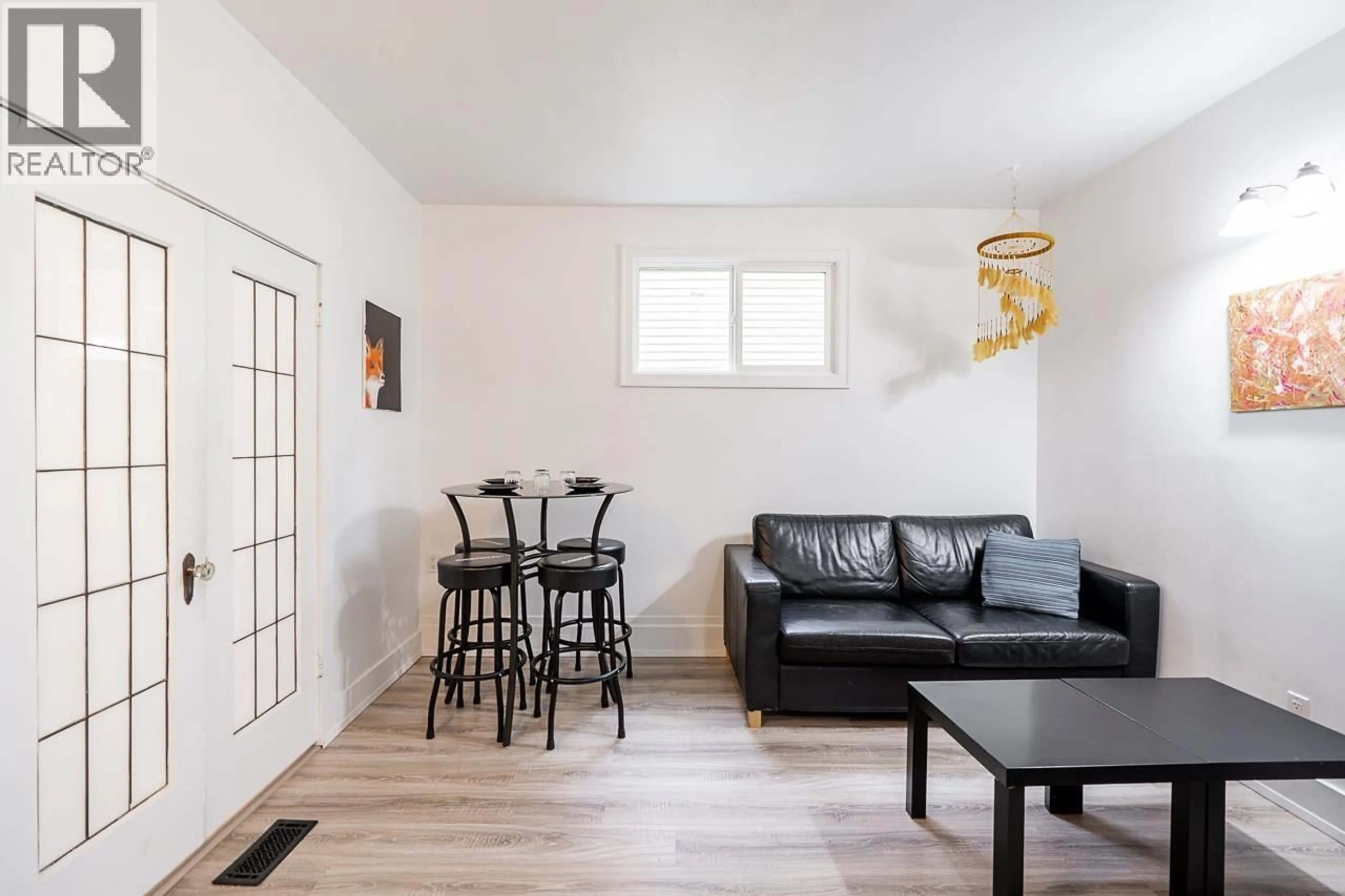 Living room with furniture, wood/laminate floor for 1620 MCLEAN DRIVE, Vancouver British Columbia V5L3P3