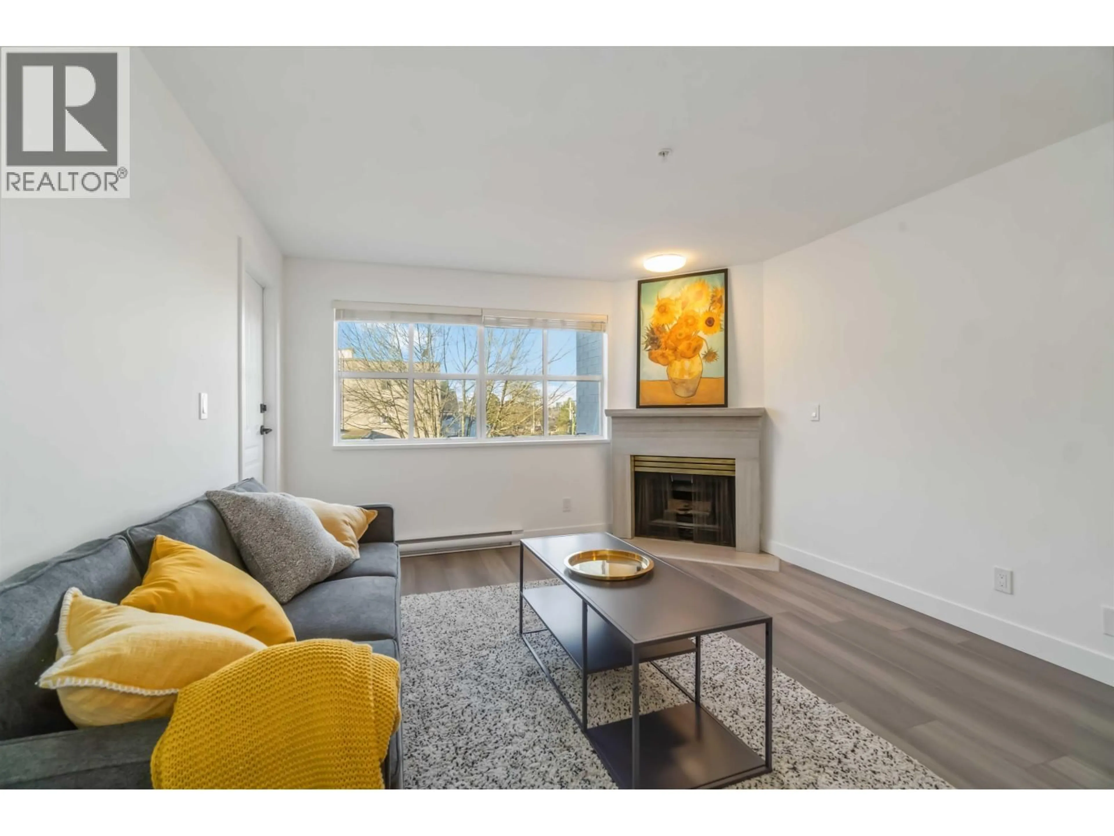 Living room with furniture, wood/laminate floor for 309 - 2928 COMMERCIAL DRIVE, Vancouver British Columbia V5N4C9