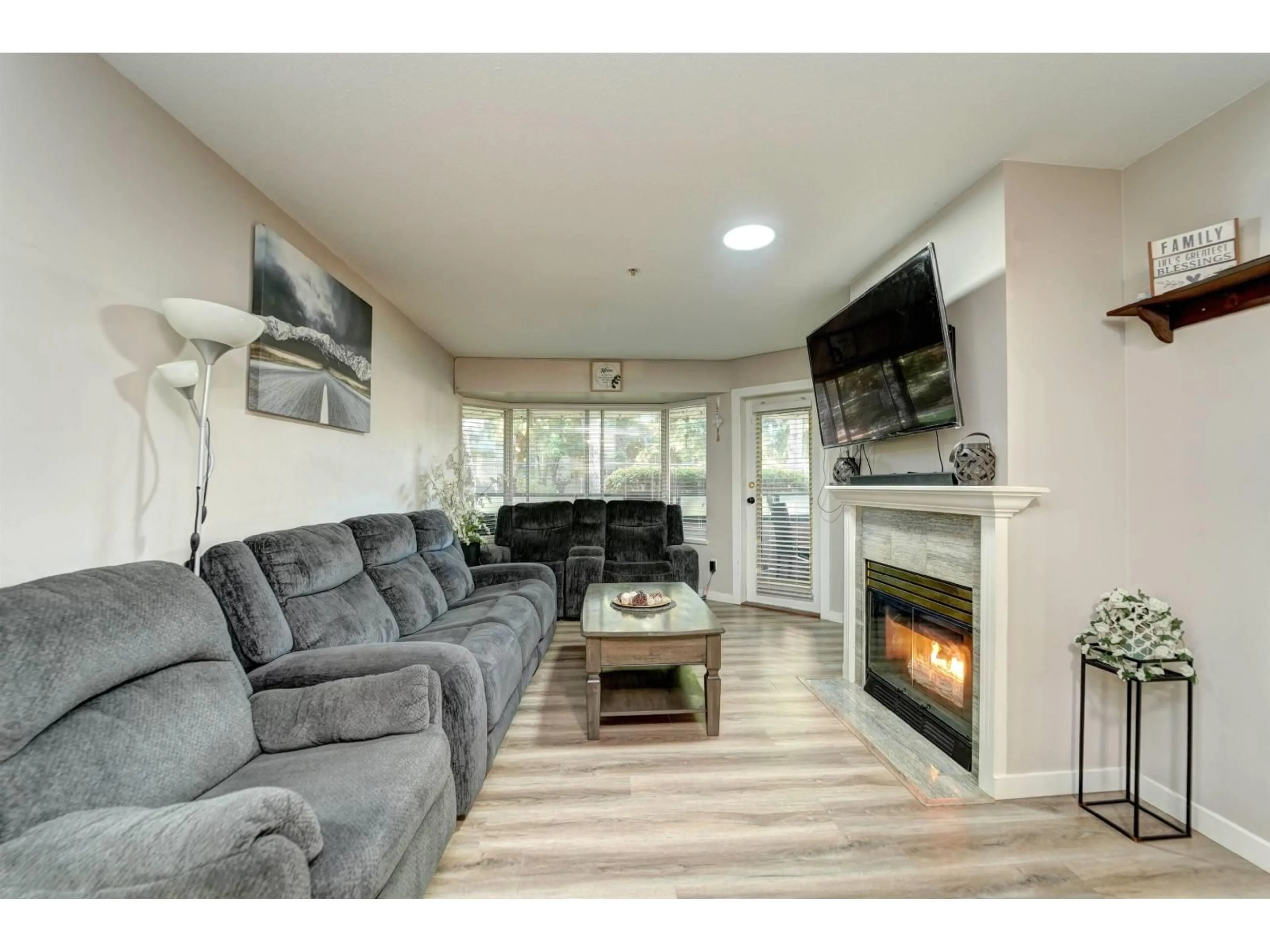 Living room with furniture, wood/laminate floor for 116 - 2964 TRETHEWEY STREET, Abbotsford British Columbia V2T6P4